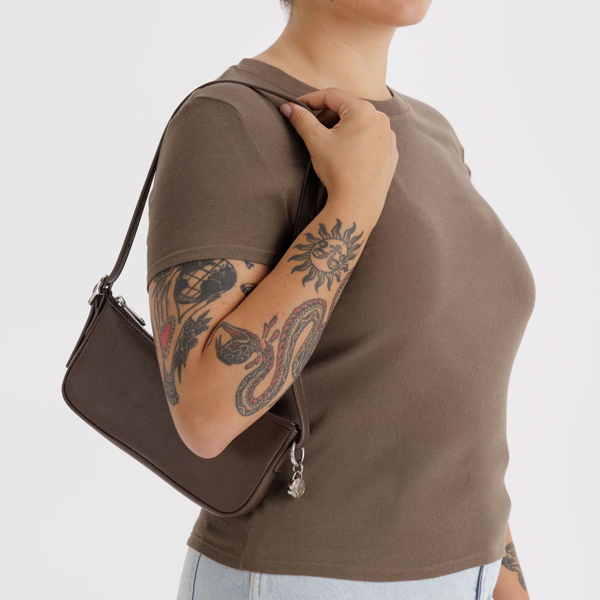 A brown recycled leather mini shoulder bag. 
