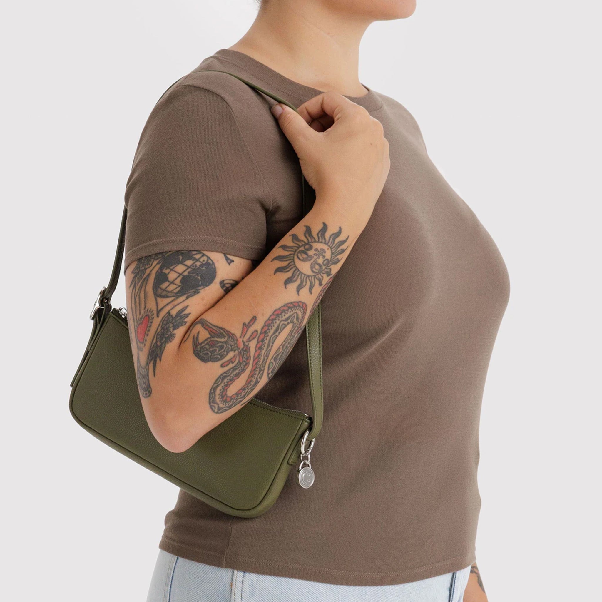 A green recycled leather shoulder bag. 