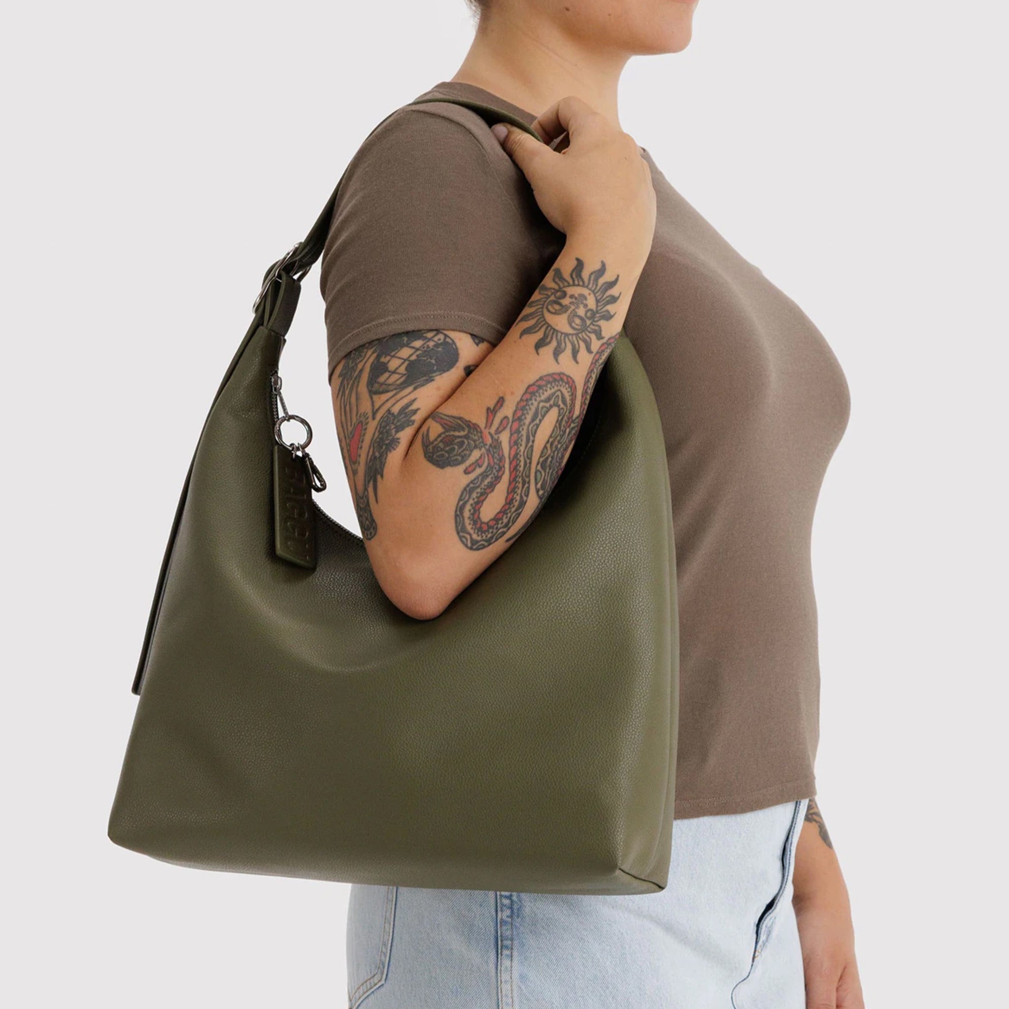 A green recycled leather shoulder bag. 