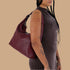 A mahogany colored leather shoulder bag. 