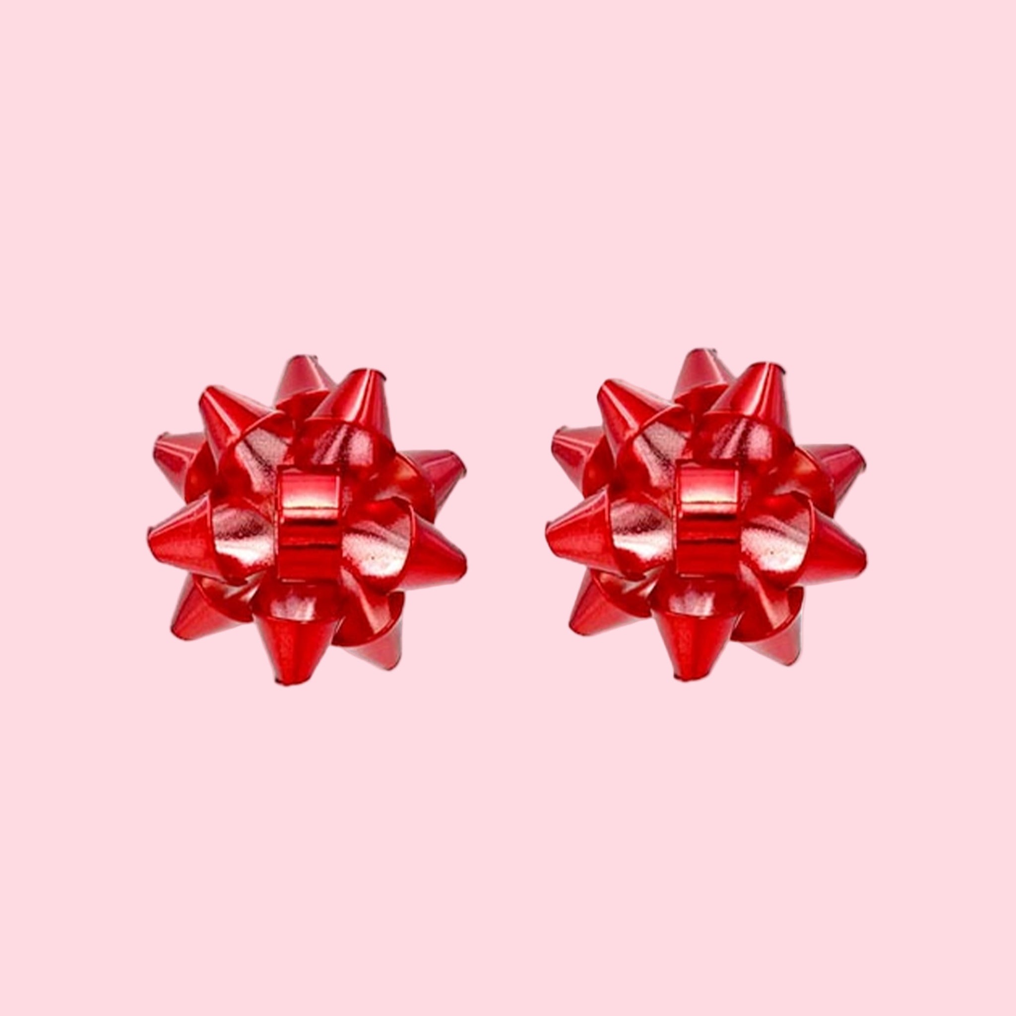 A pair of red bow shaped stud earrings. 