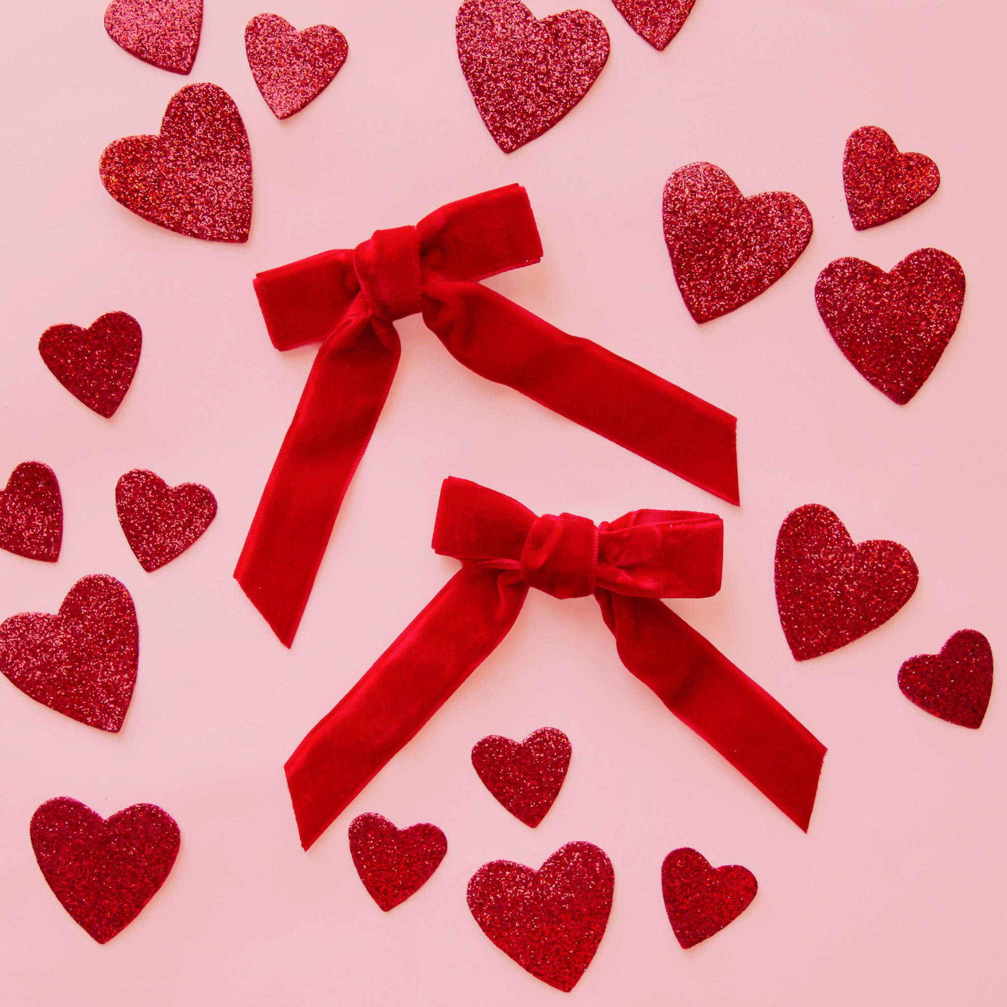 A set of red hair bows. 