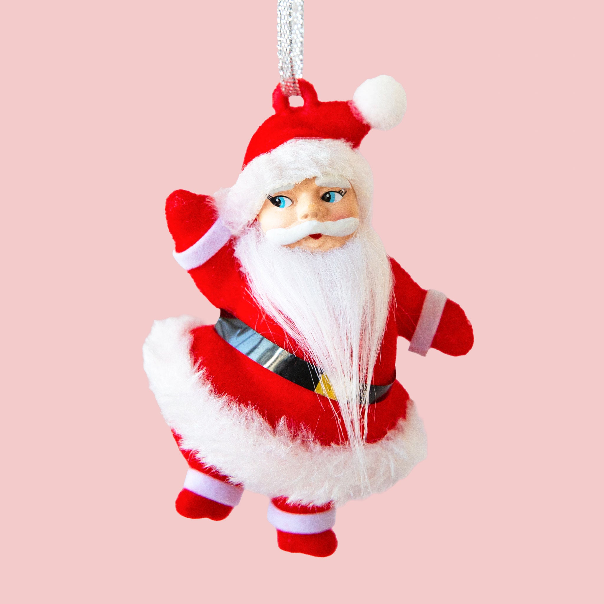 A santa ornament in a bright red velvet suit.