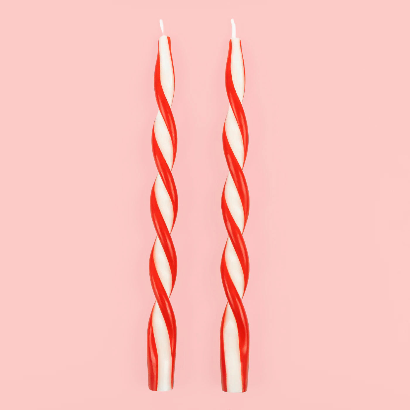 A red and white twist taper candle set of two. 