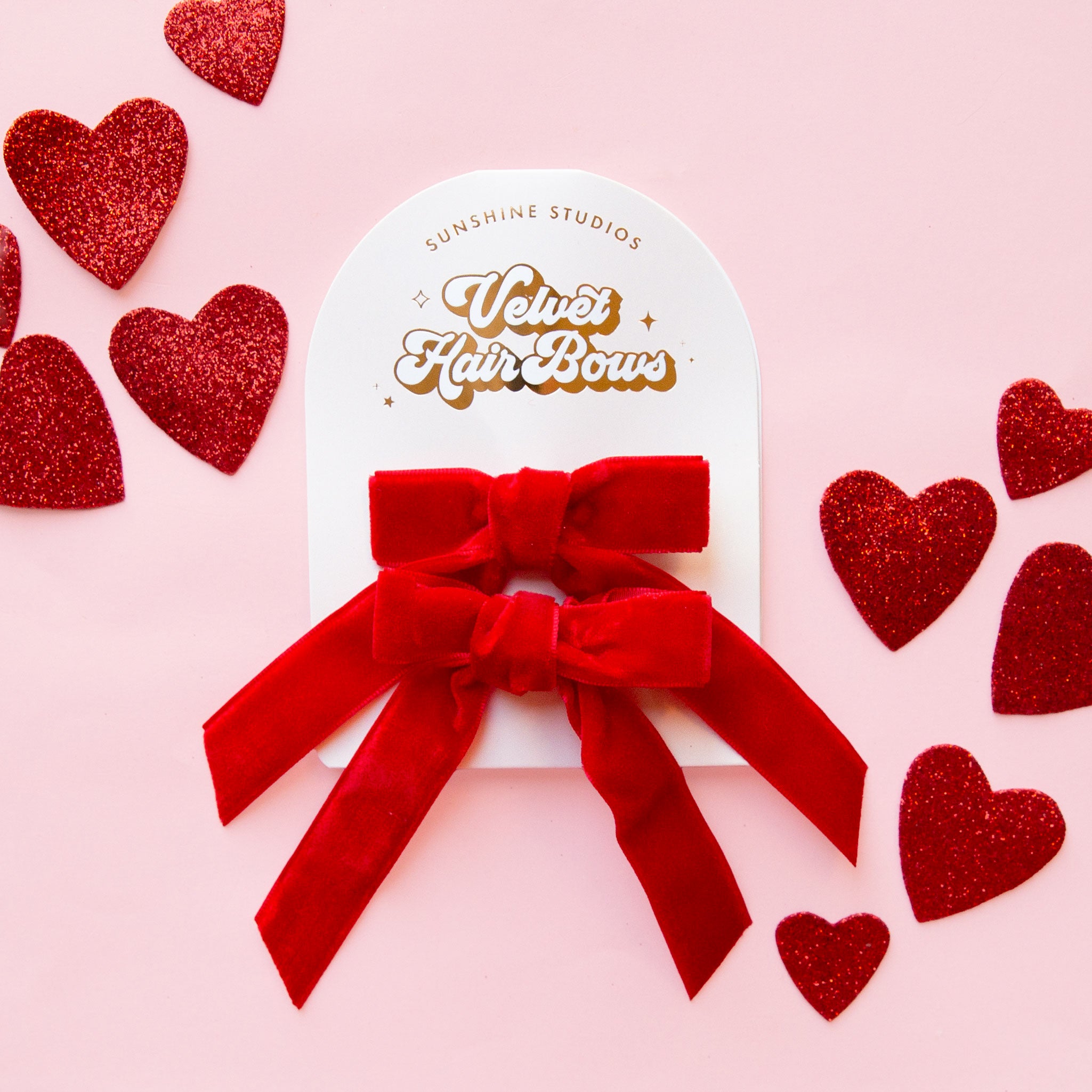 A set of red hair bows. 