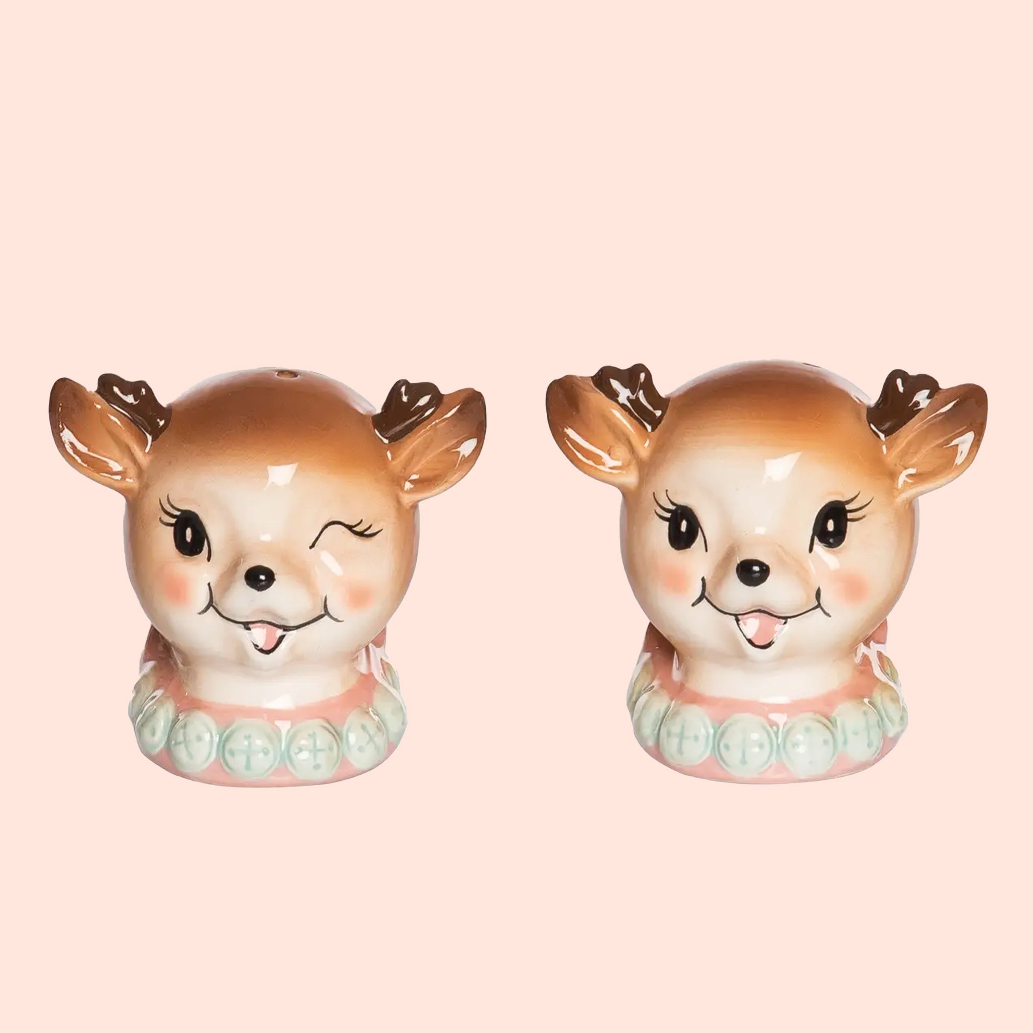 A pair of ceramic salt and pepper shakers in the shape of holiday reindeer heads. 