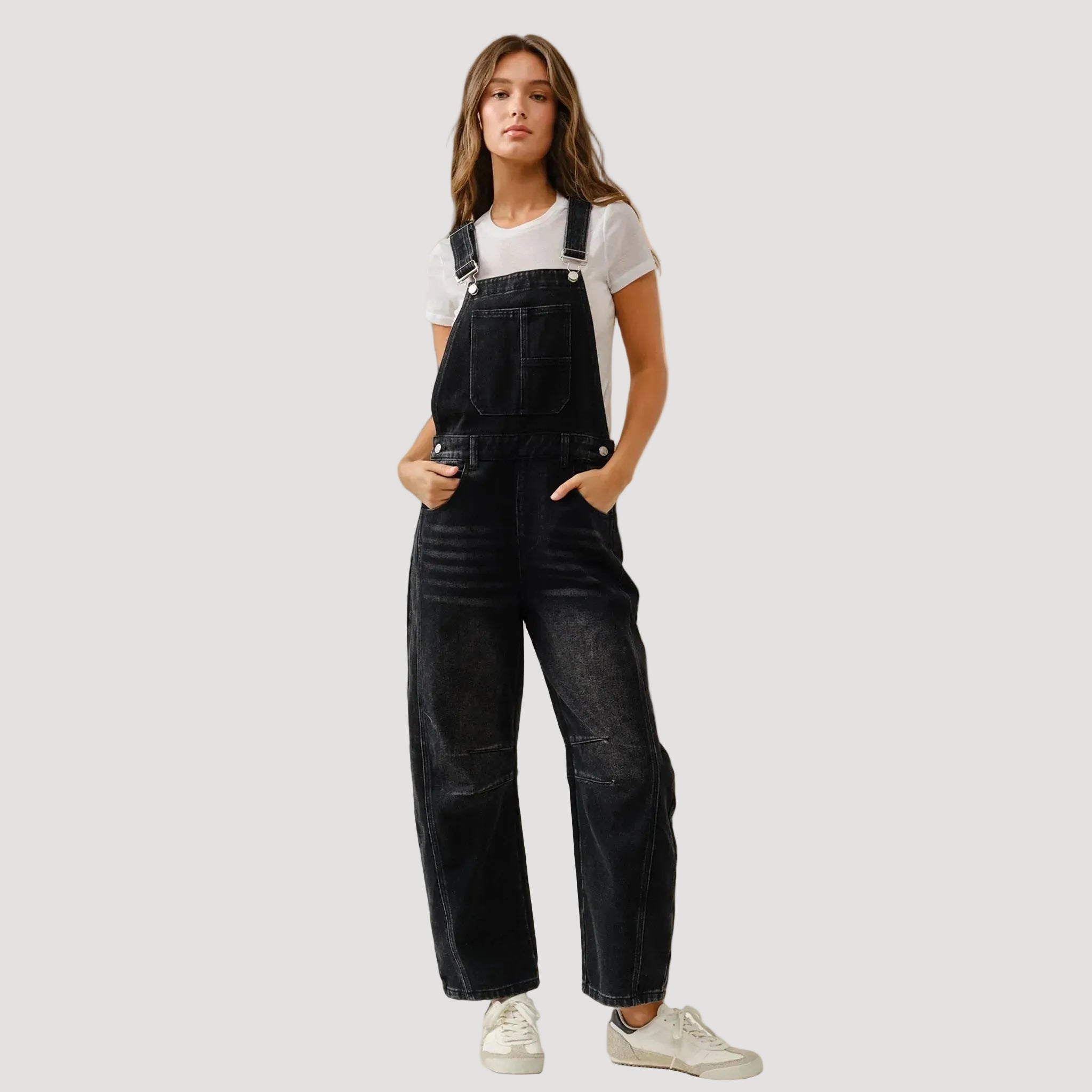 A black pair of denim slouchy overalls. 