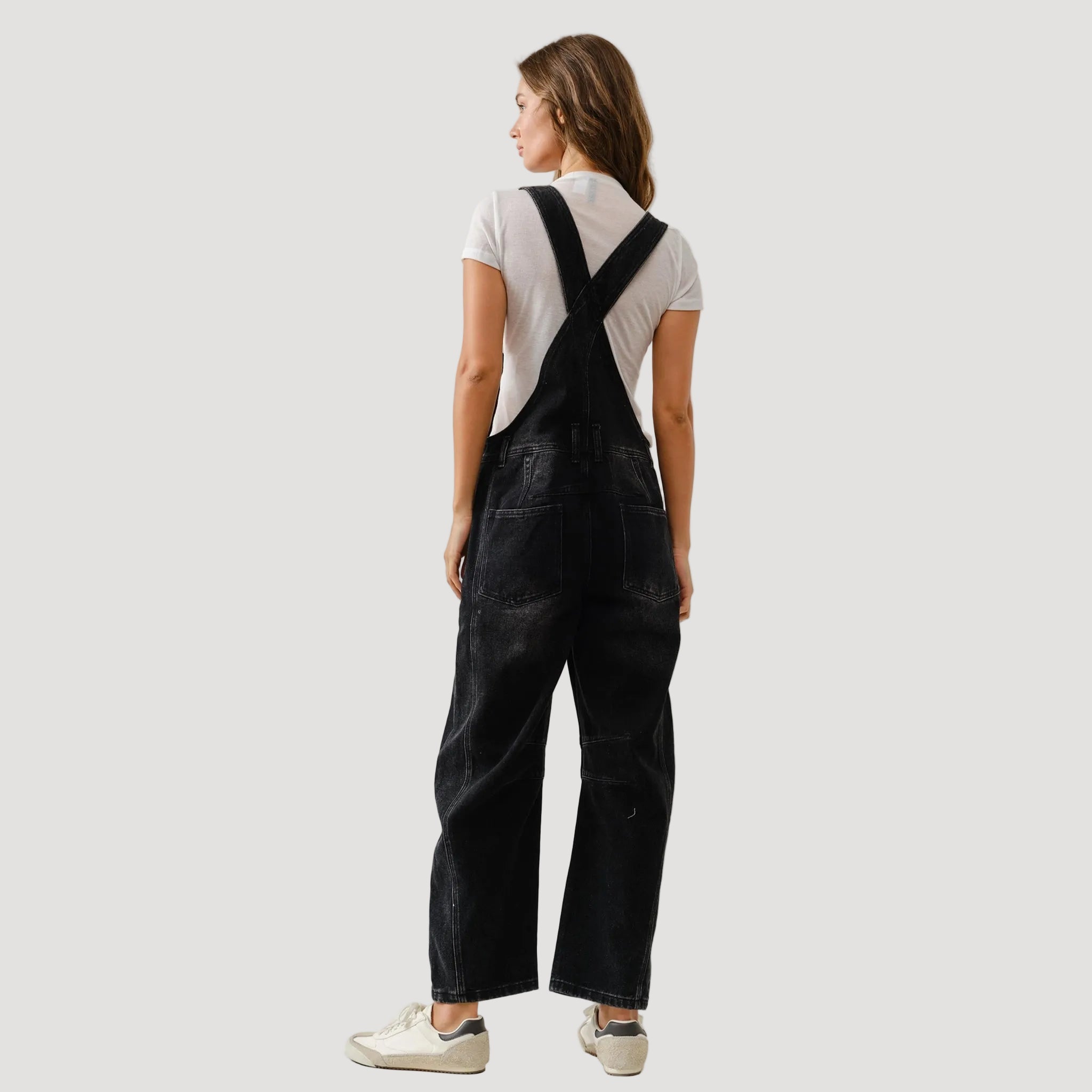 A black pair of denim slouchy overalls. 