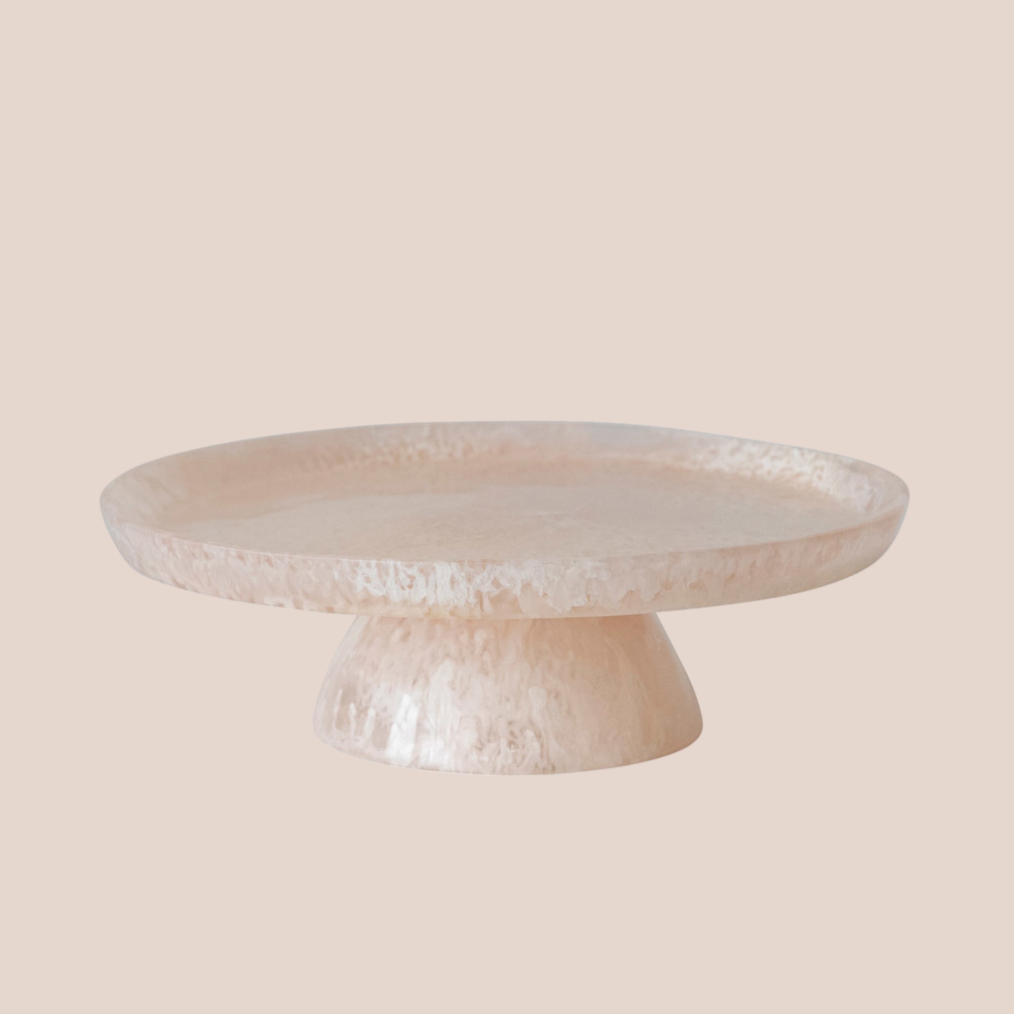 A light pink resin pedestal tray. 