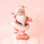 On a peachy pink background is a peach colored santa figurine. 