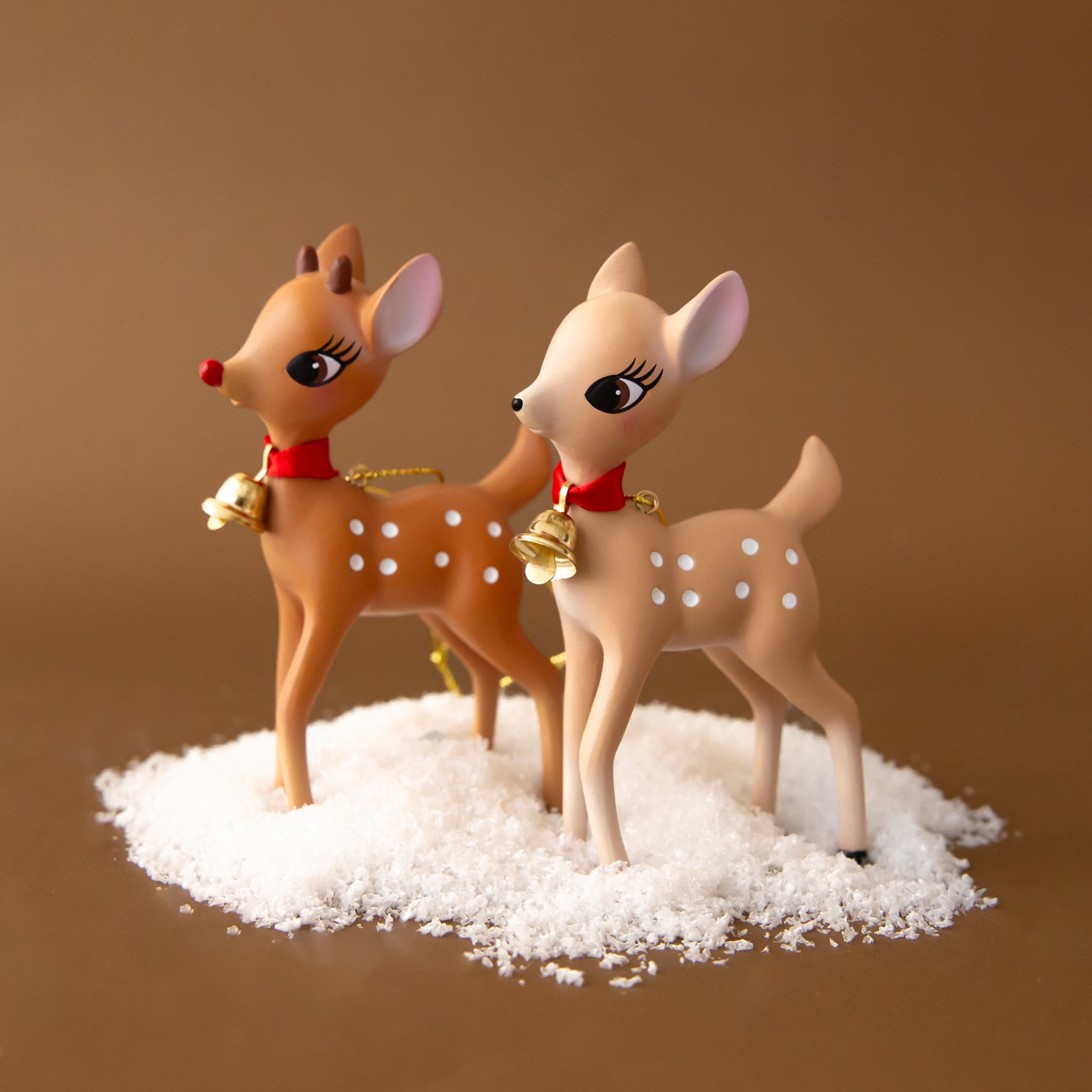A light tan retro deer figurine with a red collar and bell. 