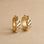 A gold pair of earrings with mother of pearl. 