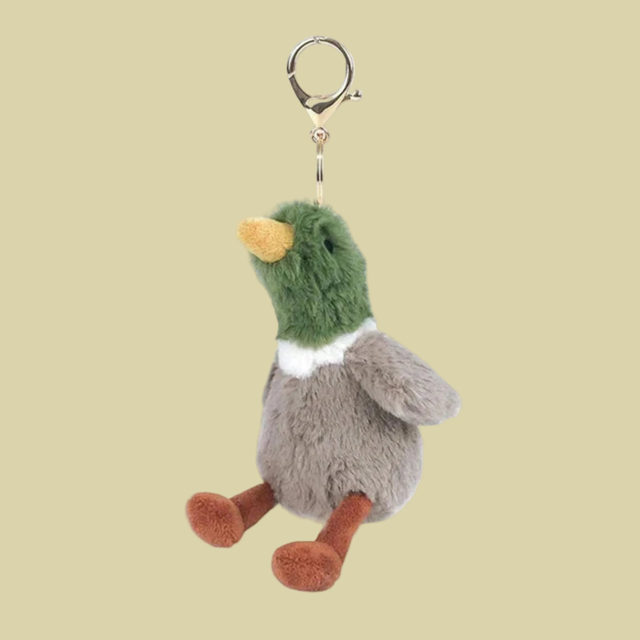 A duck shaped stuffed toy keychain. 