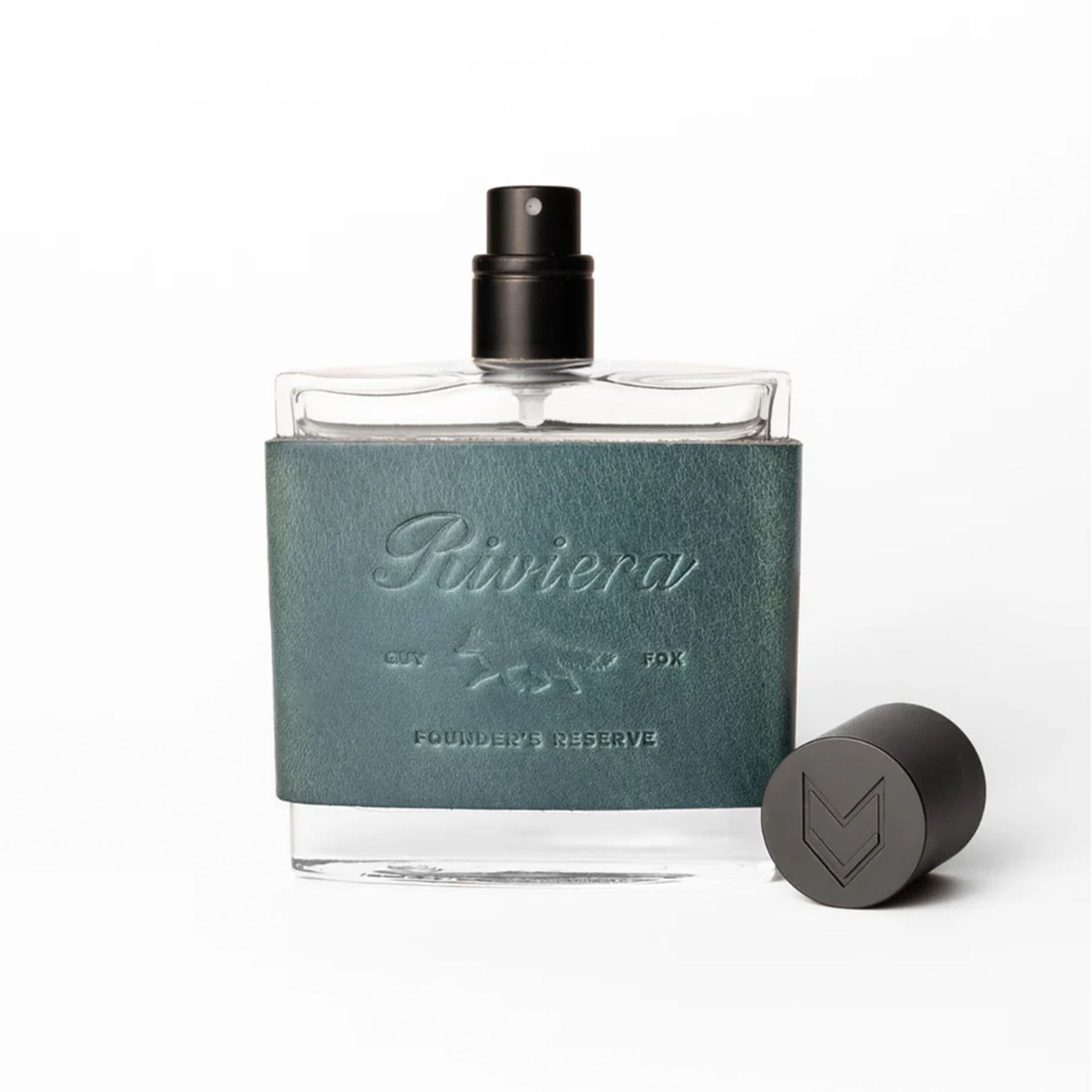 Cologne bottle with green leather cap and black spray nozzle on a white background