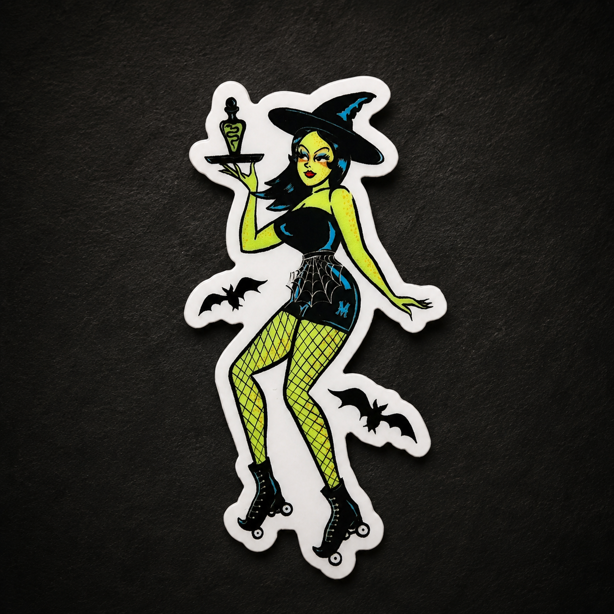 A sticker of a green witch wearing rollerskates holding a potion on a tray on a black background.