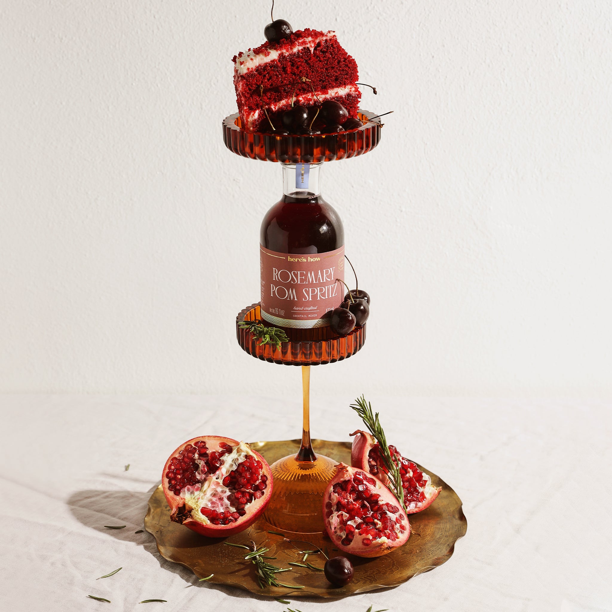 A bottle of cocktail mix with a label that reads, 'Rosemary Pom Spritz'. 