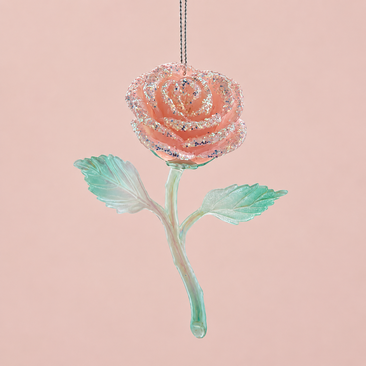 A peachy pink rose shaped glass ornament. 