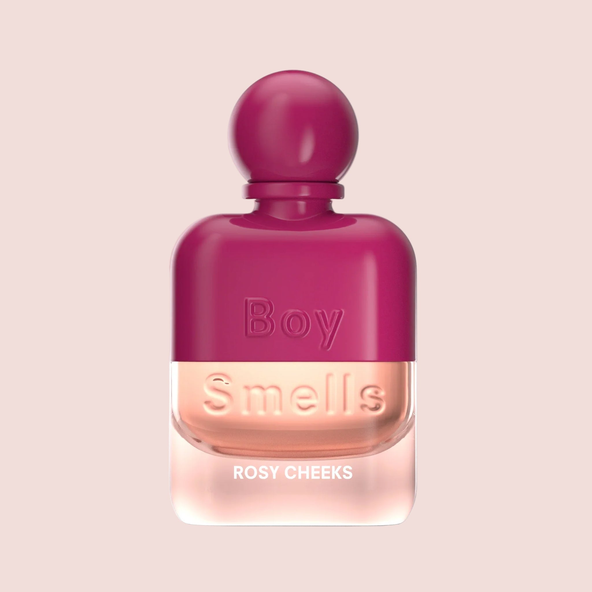 A hot pink and clear bottle of perfume with a round cap and text that reads, 'Boy Smells Rosy Cheeks'. 