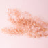 A light pink bundle of dried florals. 