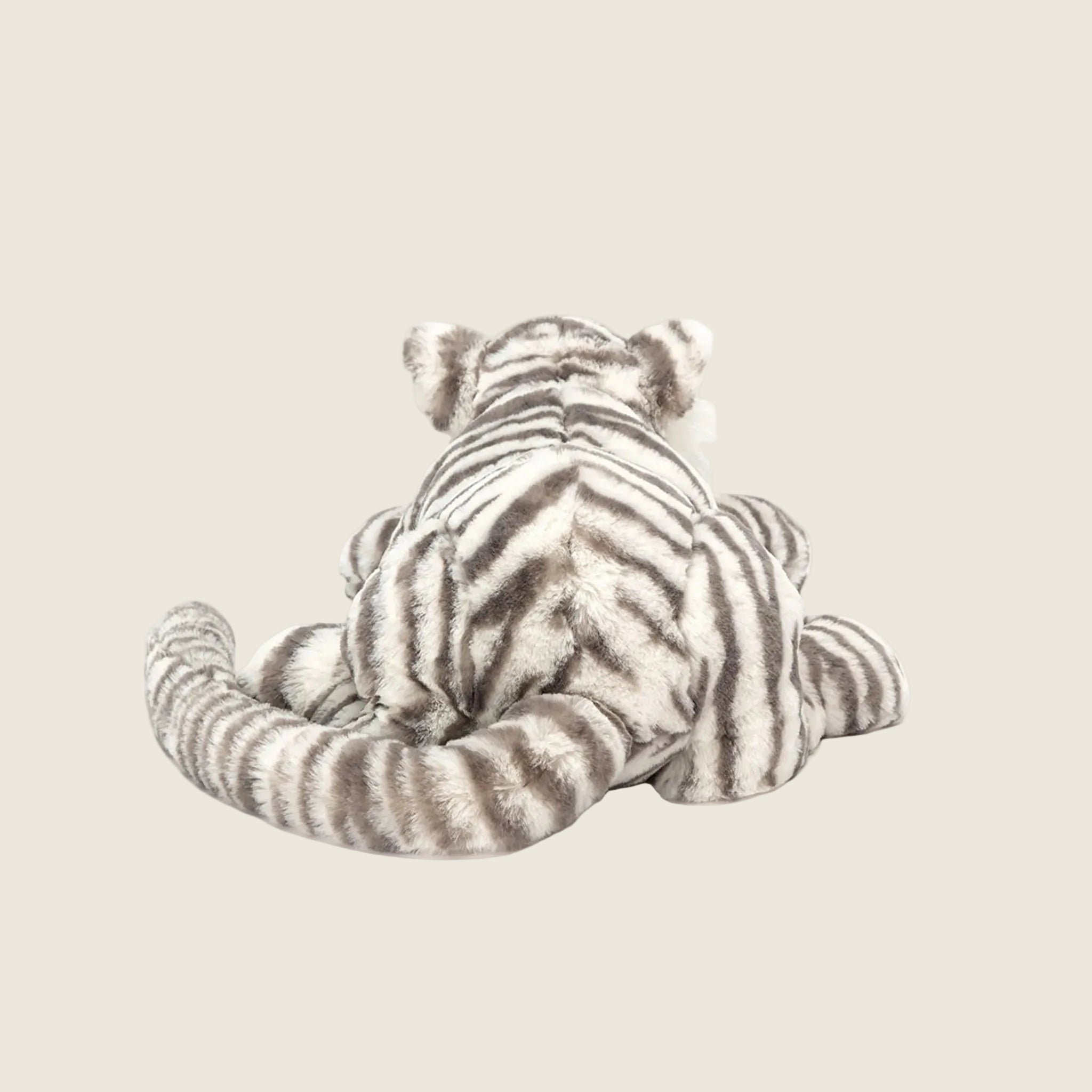 A grey and white striped tiger shaped stuffed toy. 