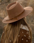 A wood brown hat with a flat brim.