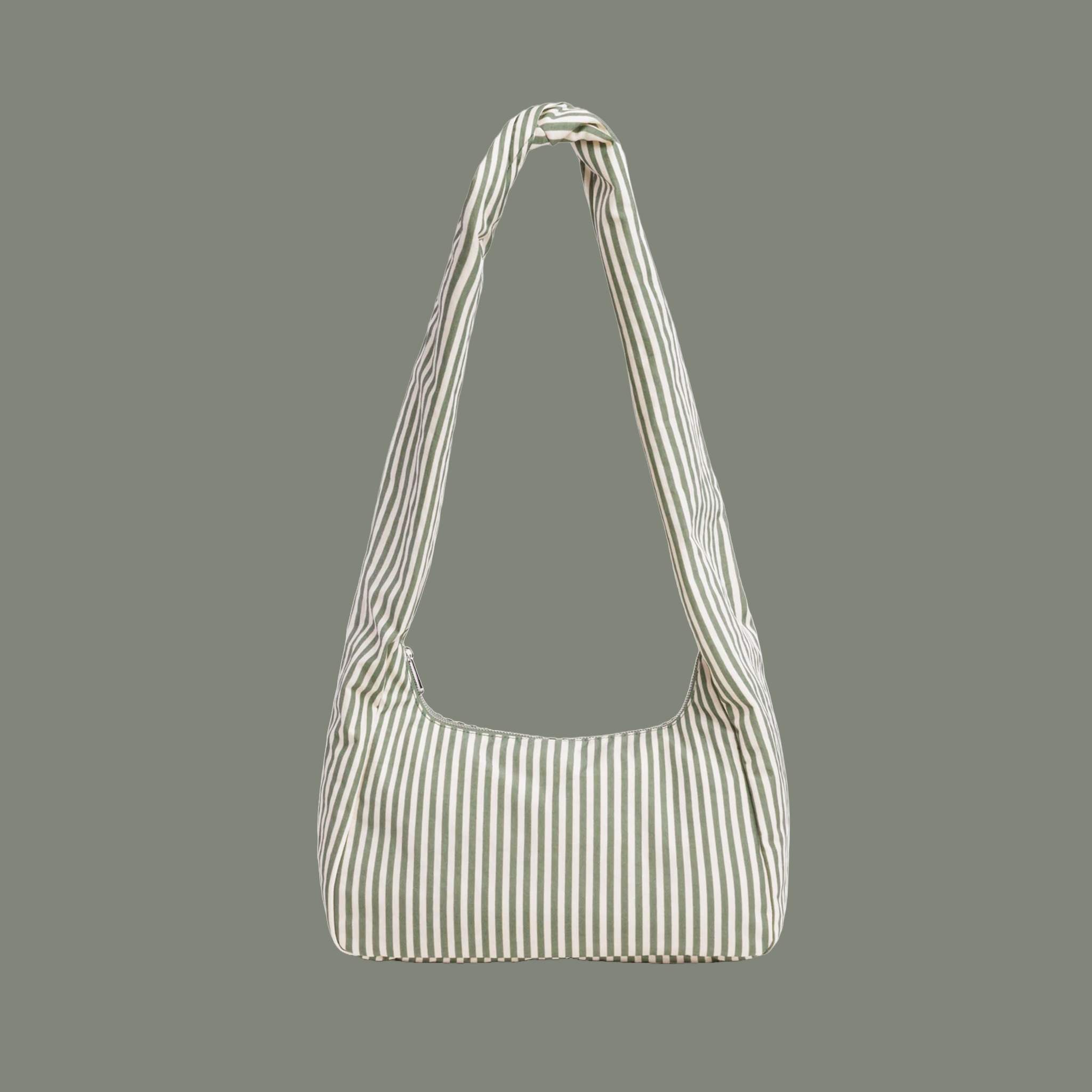 A sage striped nylon shoulder bag with long shoulder strap on a sage colored background.