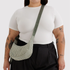 sage striped nylon purse with sage colored strap on a model.