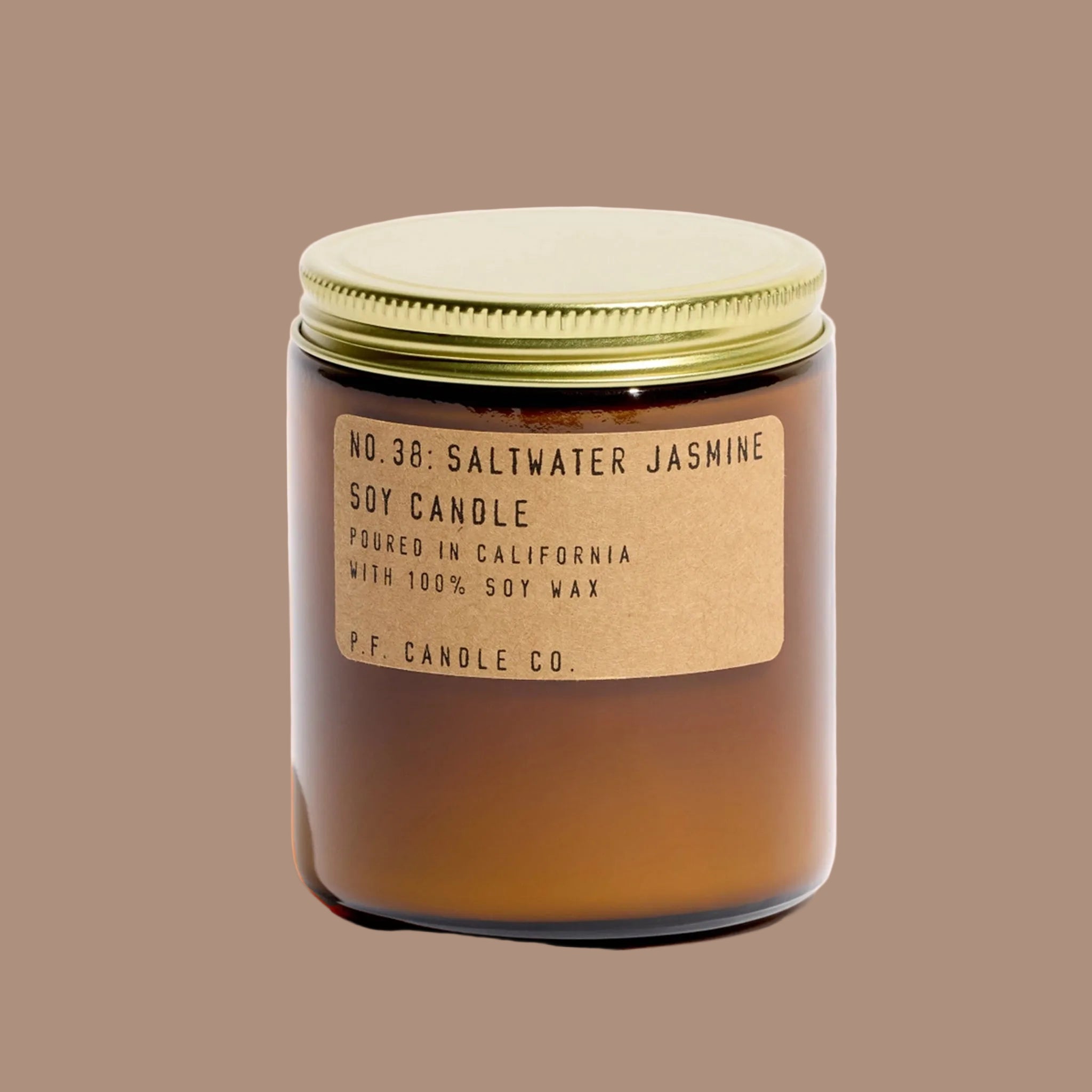 Soy candle with a gold lid and label on a white background