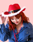 A cowboy hat with a "Santa Hat" design and a neck strap. 