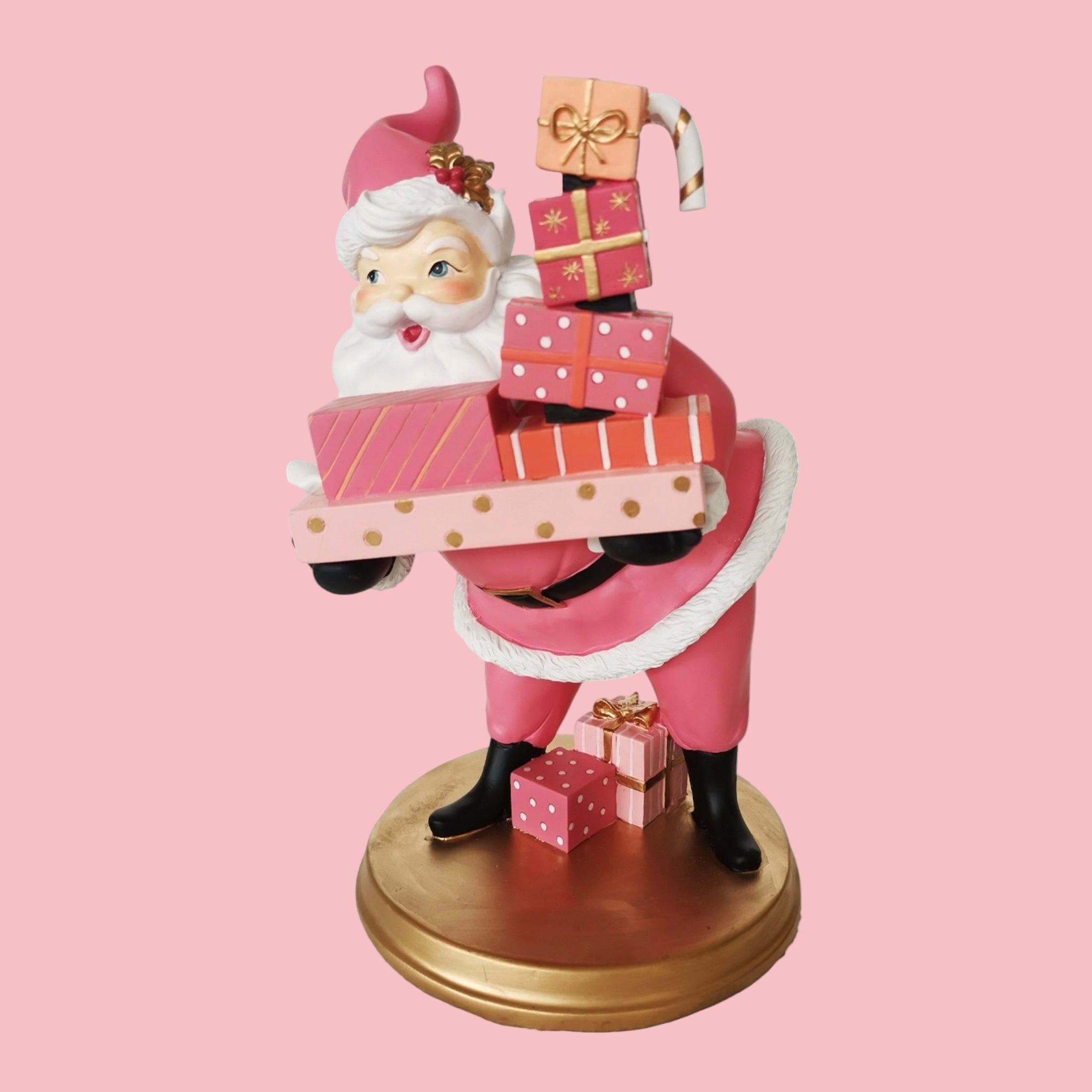 A retro style Santa figurine holding gifts. 