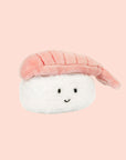 A white and peachy pink sushi shaped stuffed toy. 