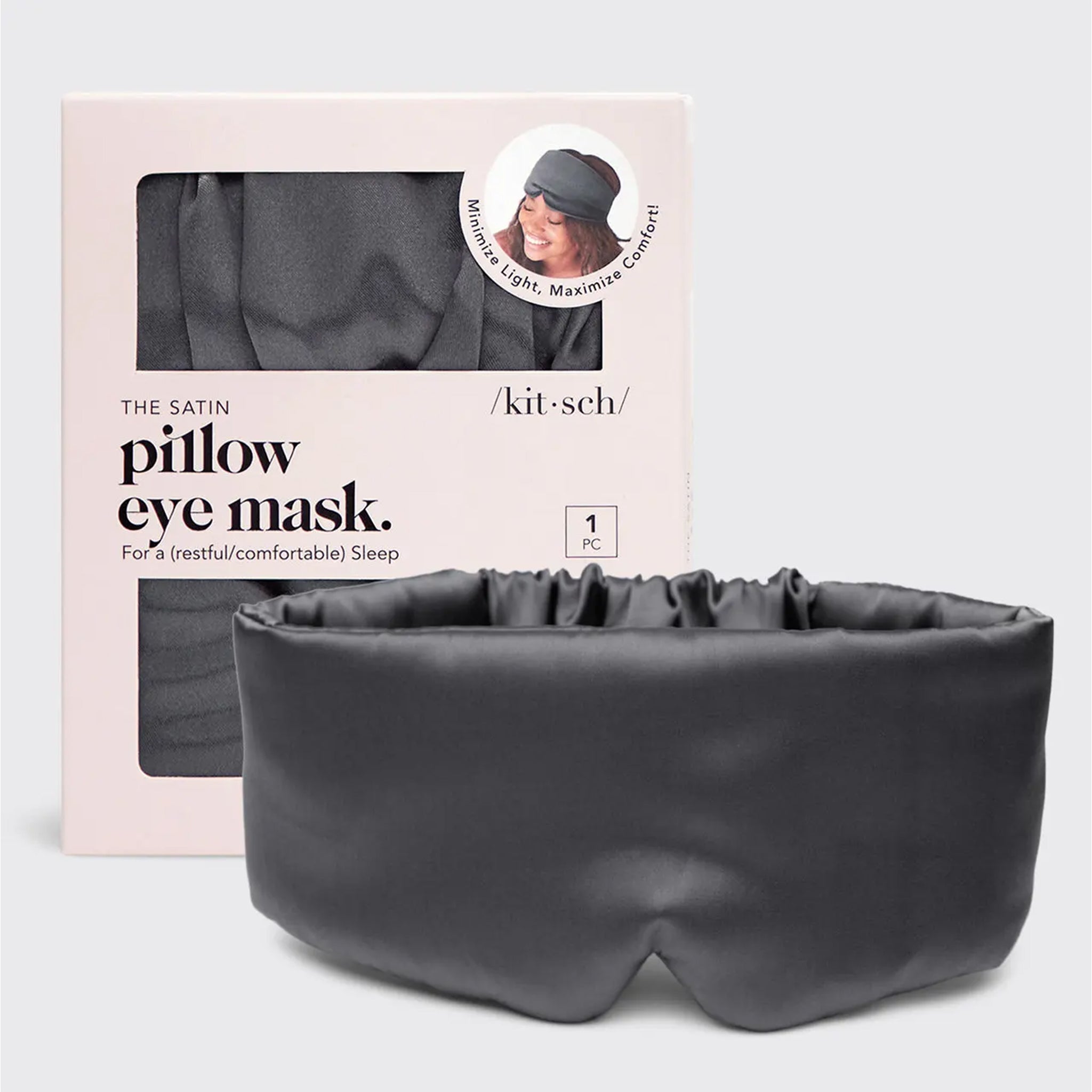 A charcoal grey satin sleeping eye mask that is slightly padded.