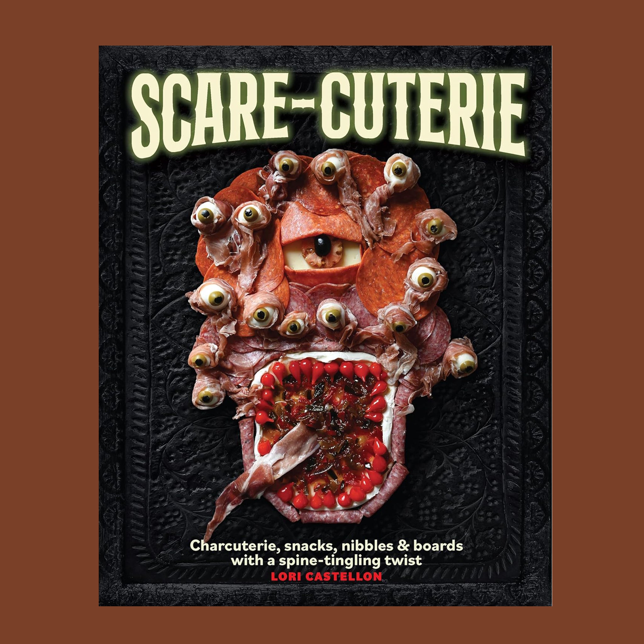 A black book cover with a spooky Halloween themed charcuterie arrangement with the title that reads, 'Scare-Cuterie Charcuterie, snacks, nibbles & boards with a spine-tingling twist'. 