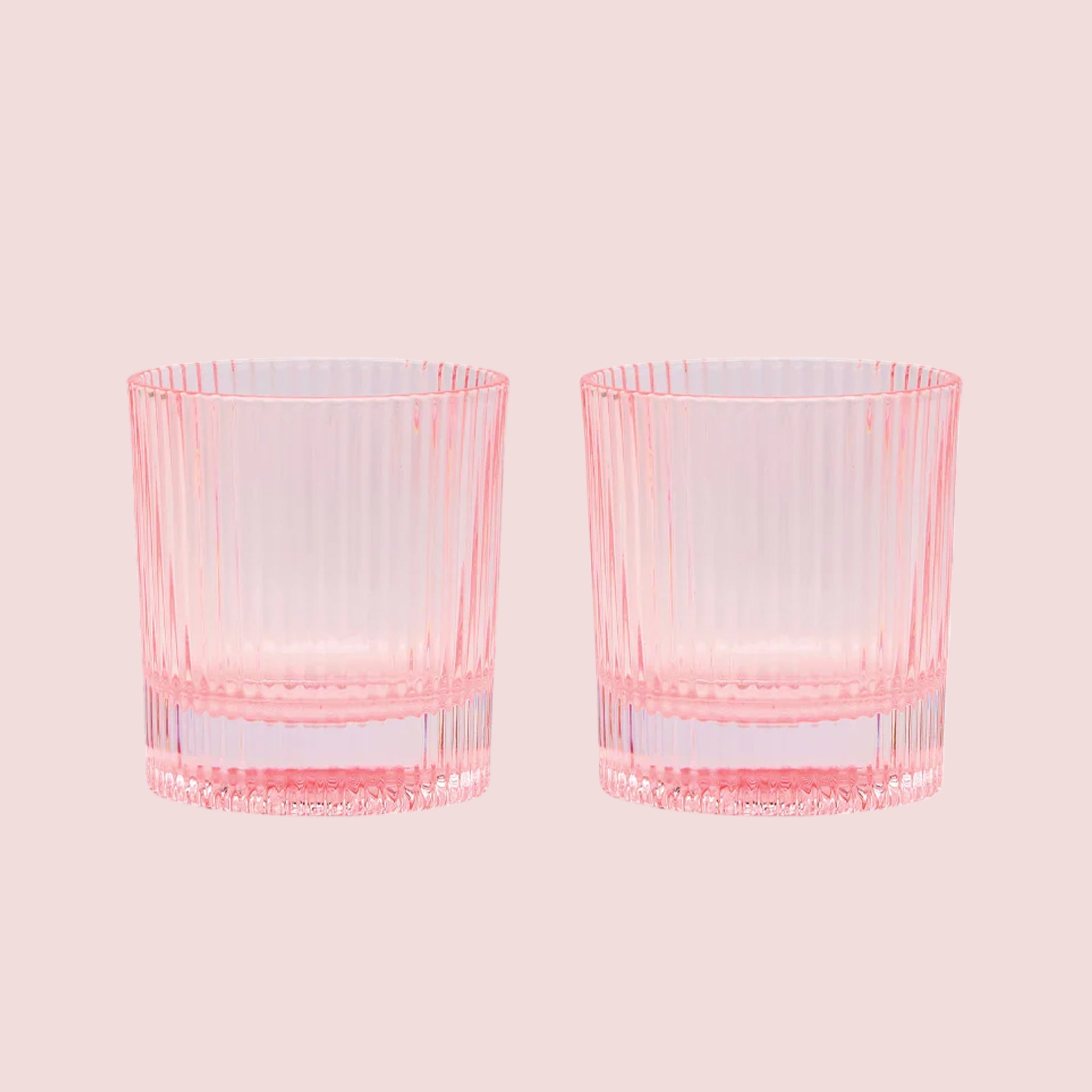 A set of pink ribbed lowball cocktail glasses. 