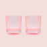 A set of pink ribbed lowball cocktail glasses. 