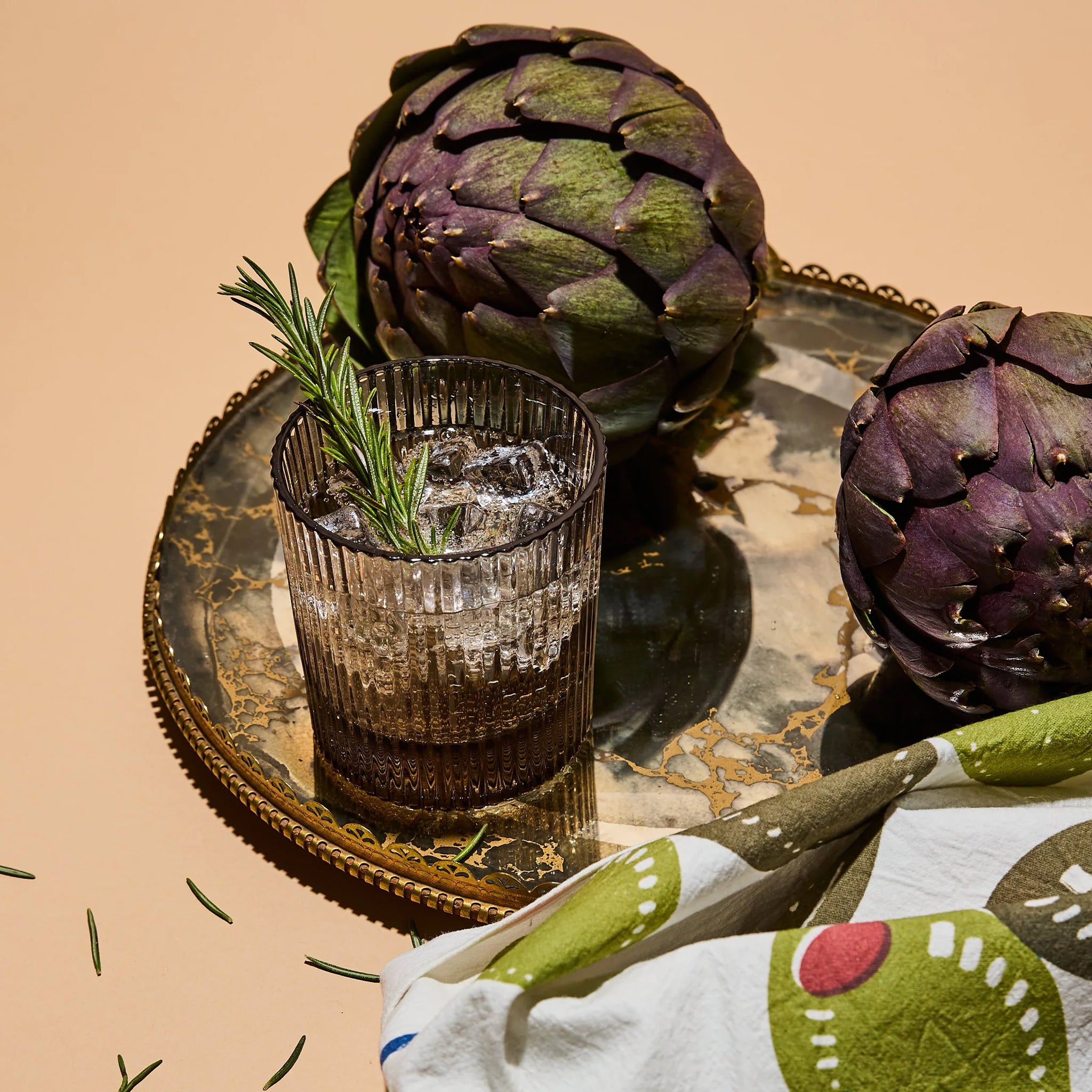 A set of lowball ribbed cocktail glasses in a smoke grey shade. 