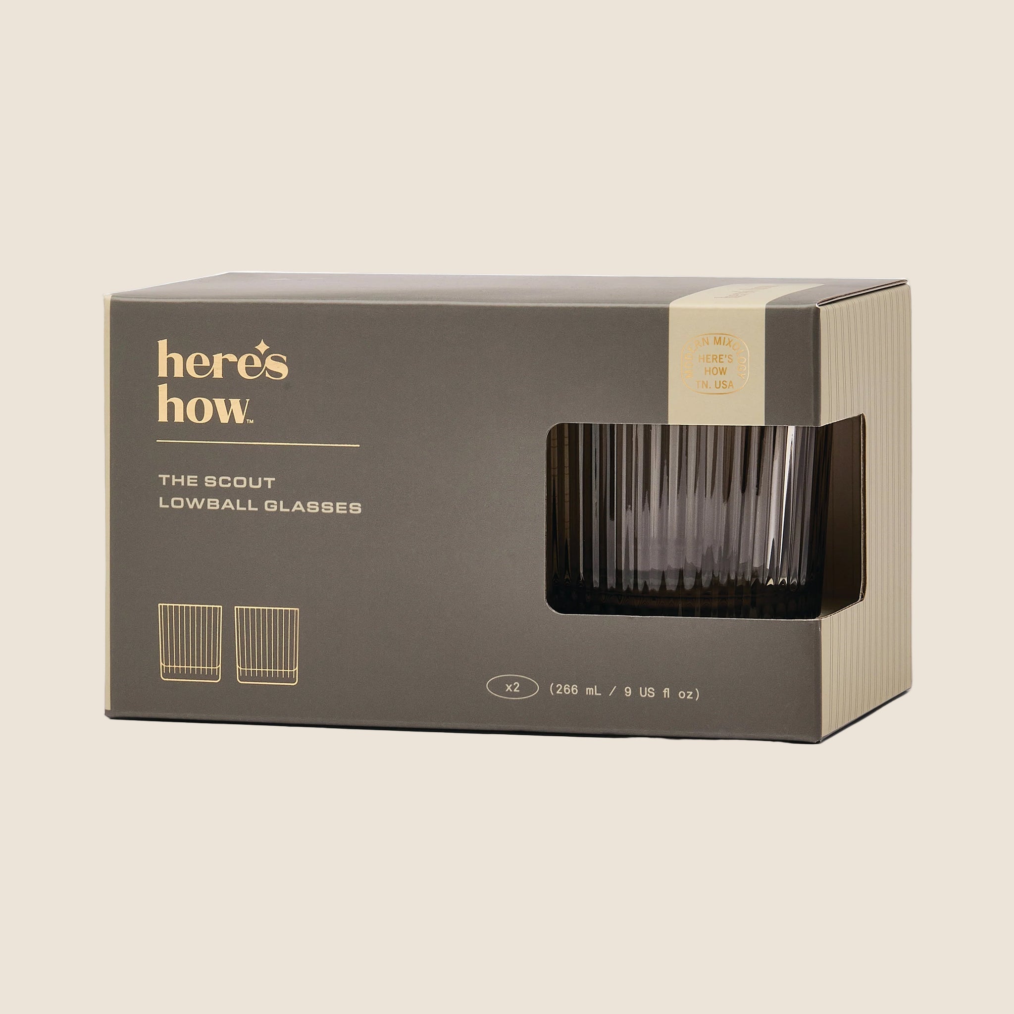 A set of lowball ribbed cocktail glasses in a smoke grey shade. 