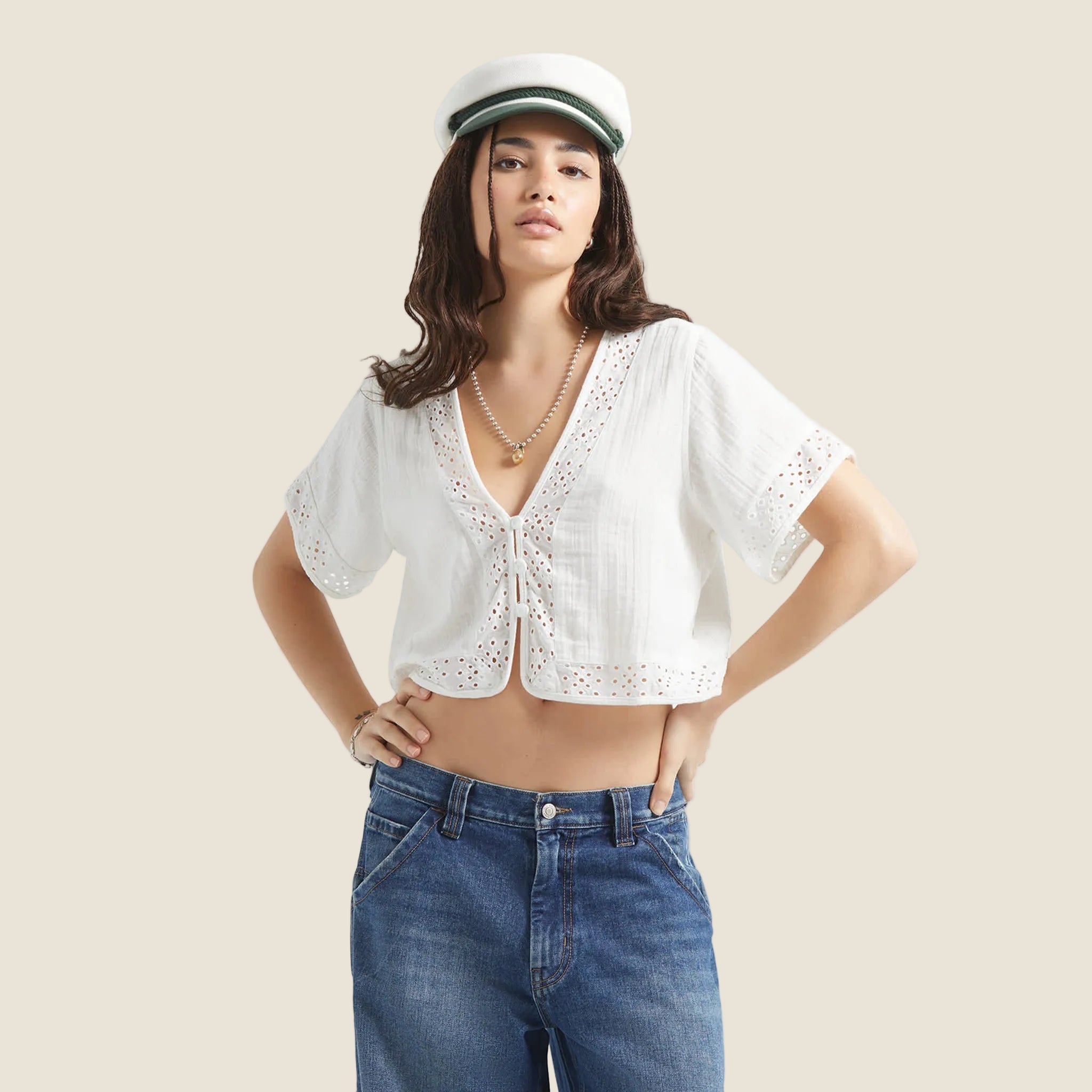 A short sleeve eyelet sleeve and neckline white crop top button up. 