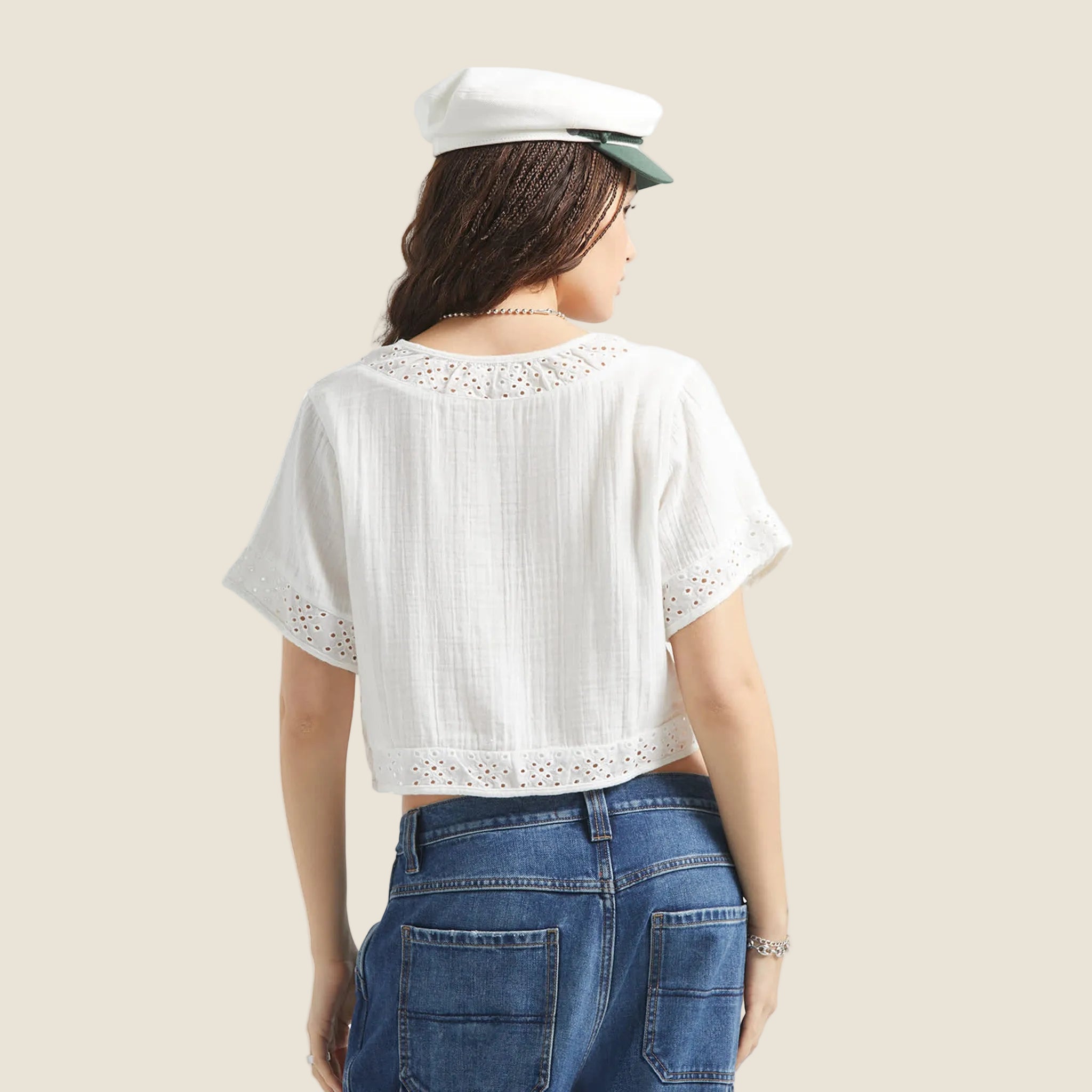 A short sleeve eyelet sleeve and neckline white crop top button up. 