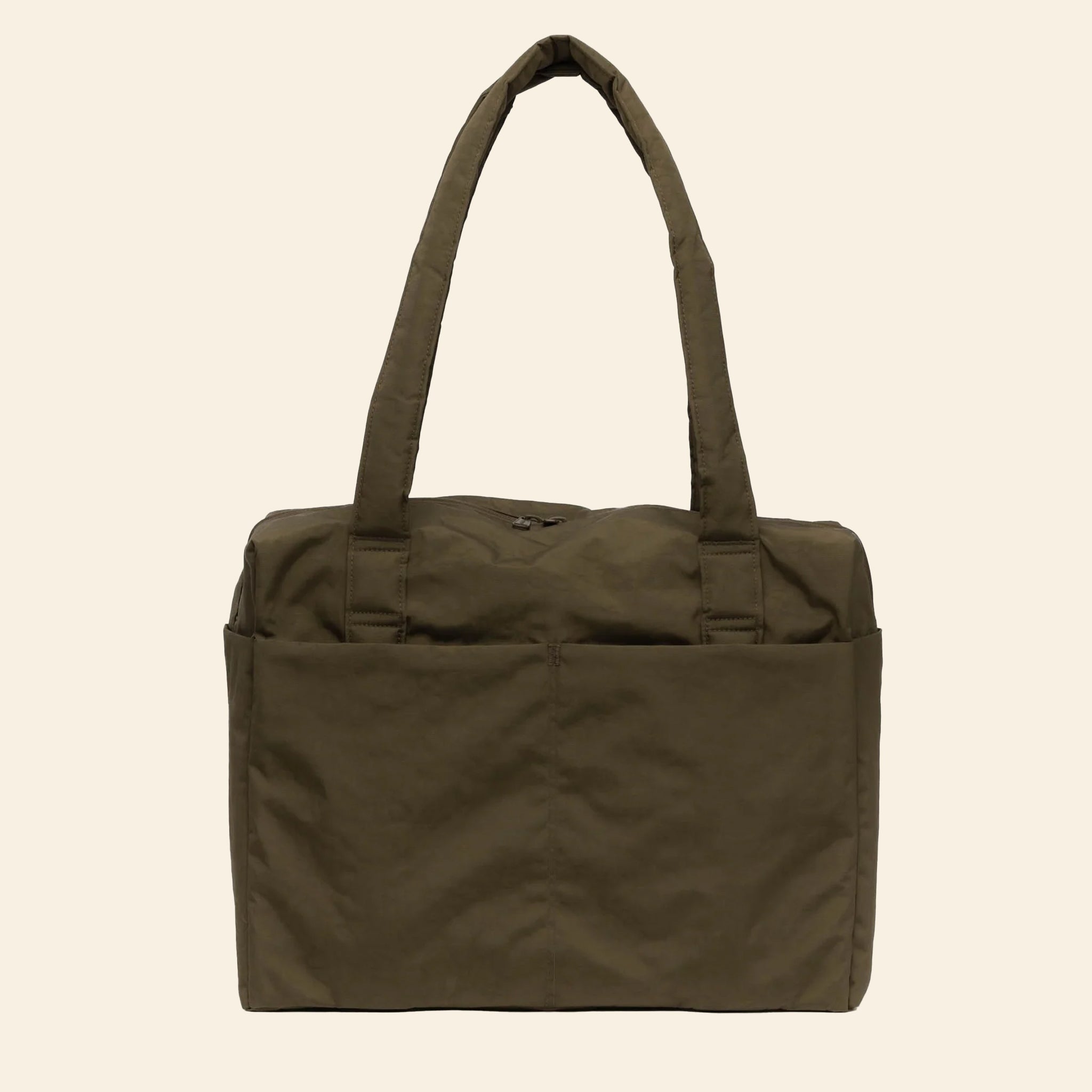 An olive green nylon travel tote bag with a strap to attach to your suitcase handle along with front pockets, a zipper closure and two shoulder strap handles.