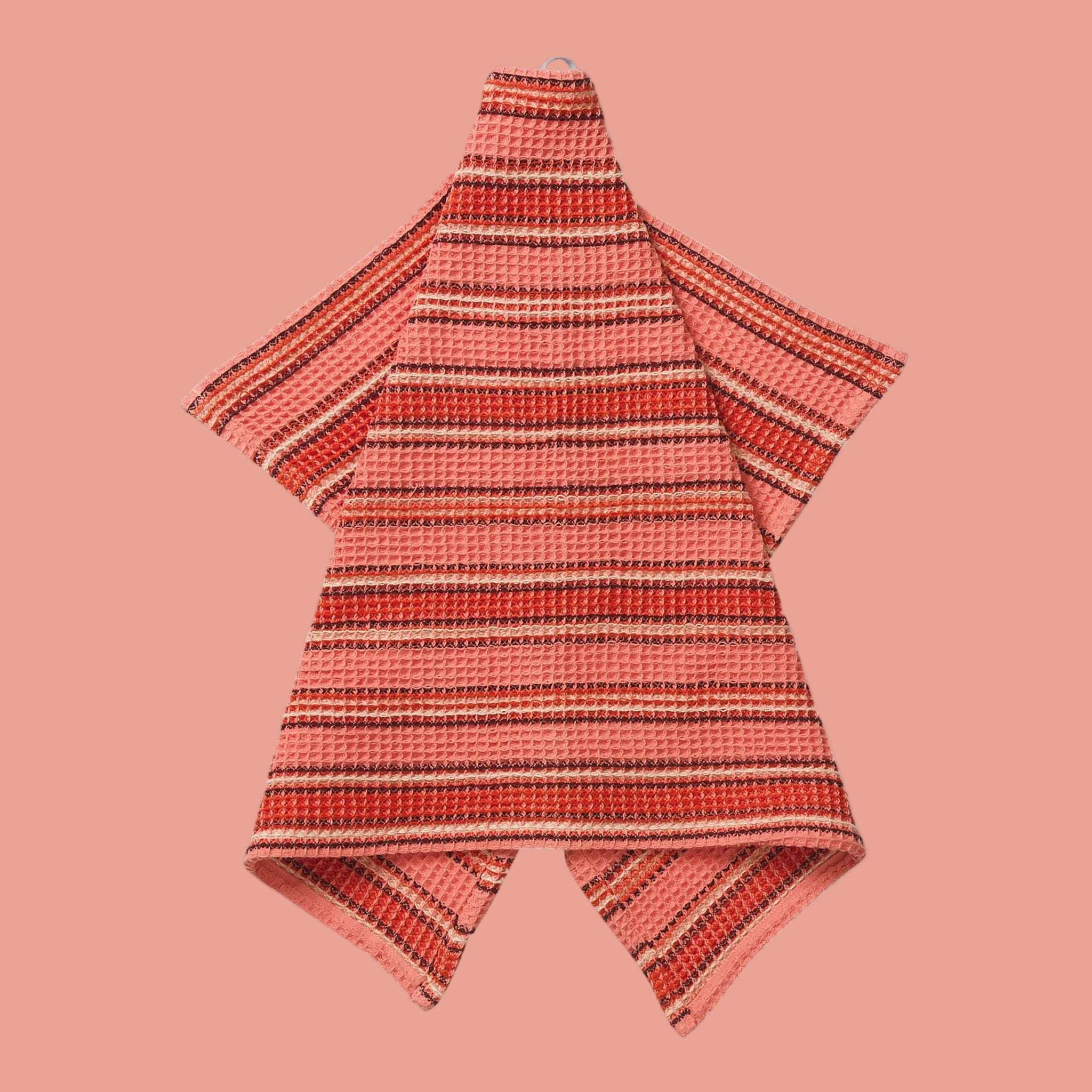 A coral striped waffle knit tea towel. 