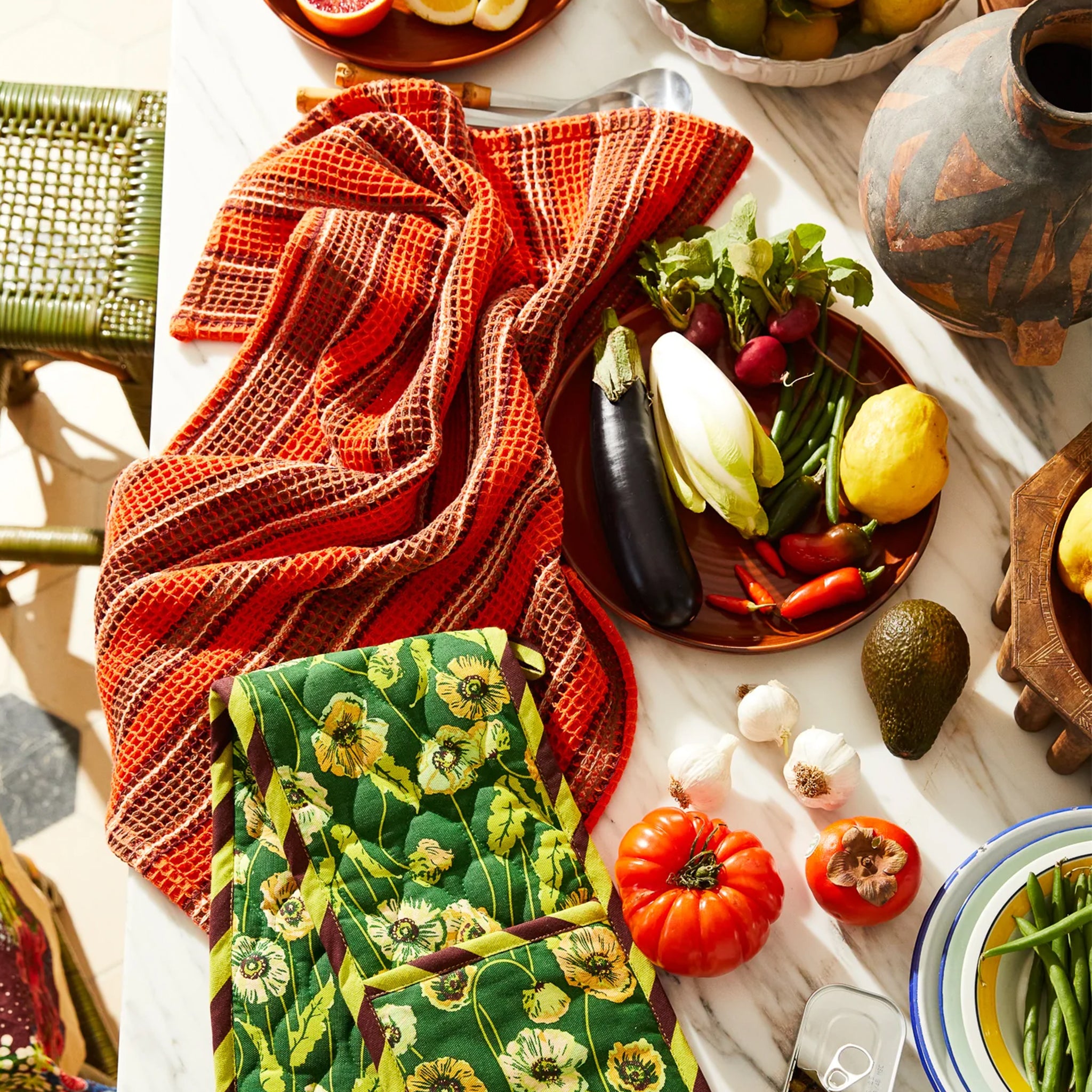 An orange and brown striped waffle knit tea towel. 
