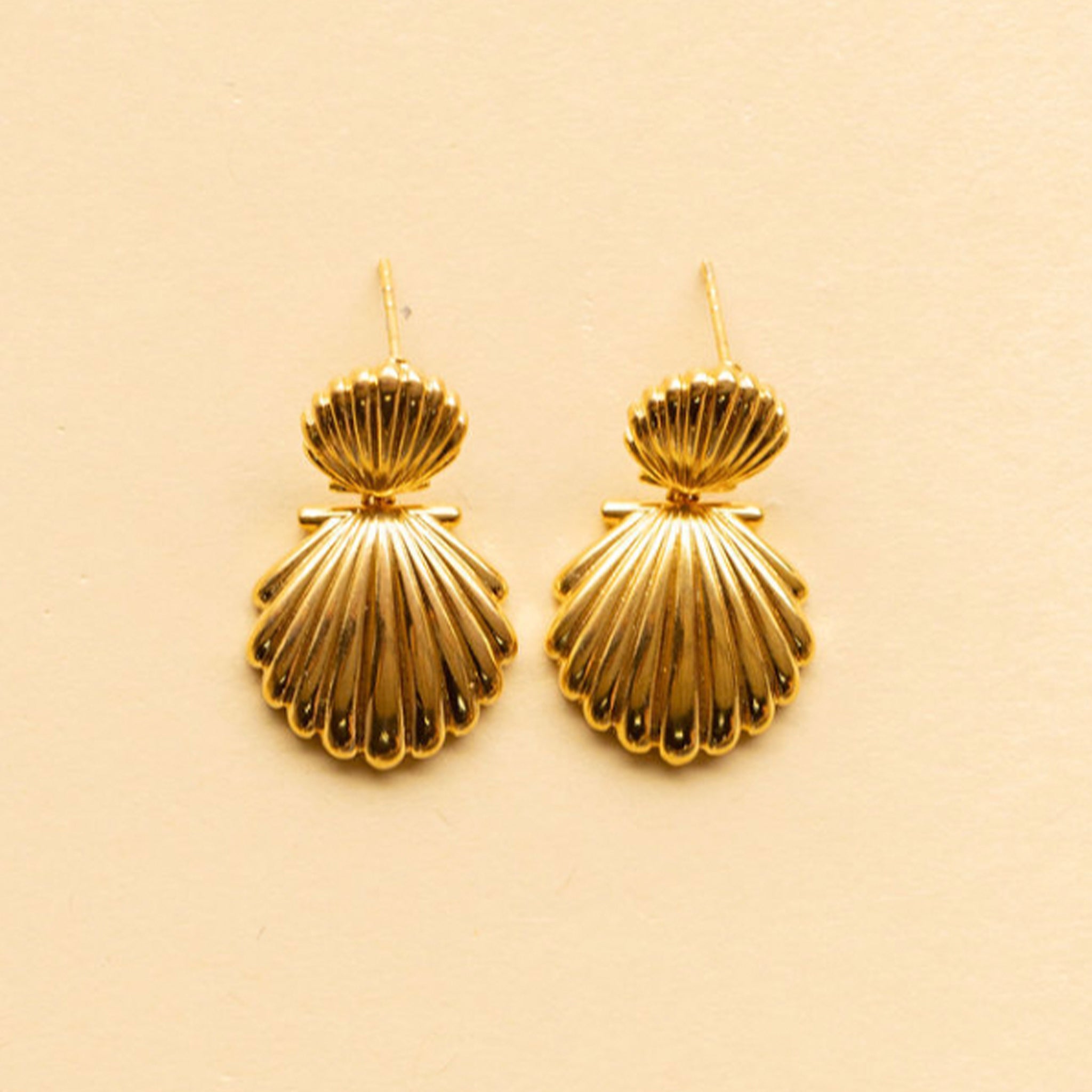A gold pair of shell earrings. 