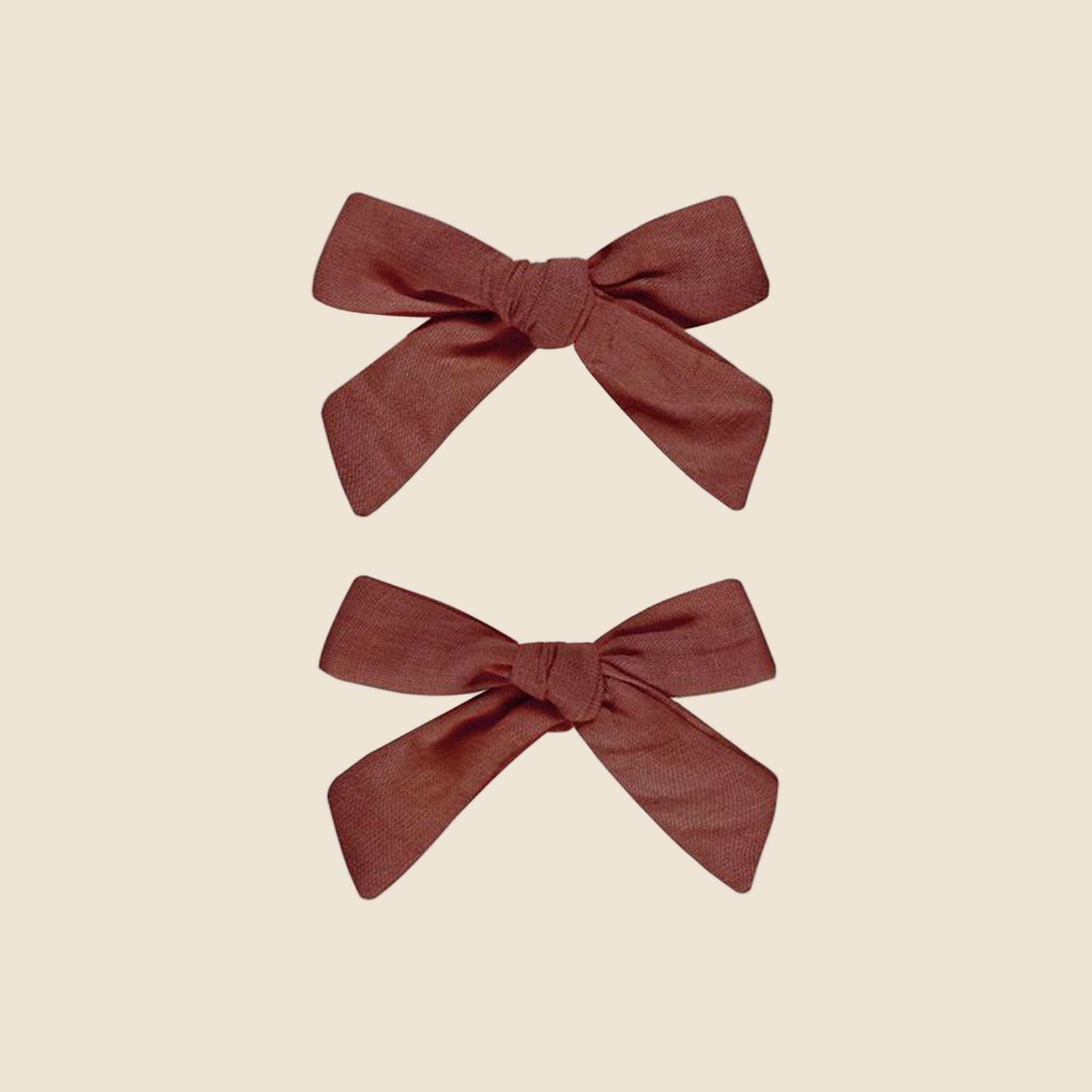 A pair of burgundy bows. 