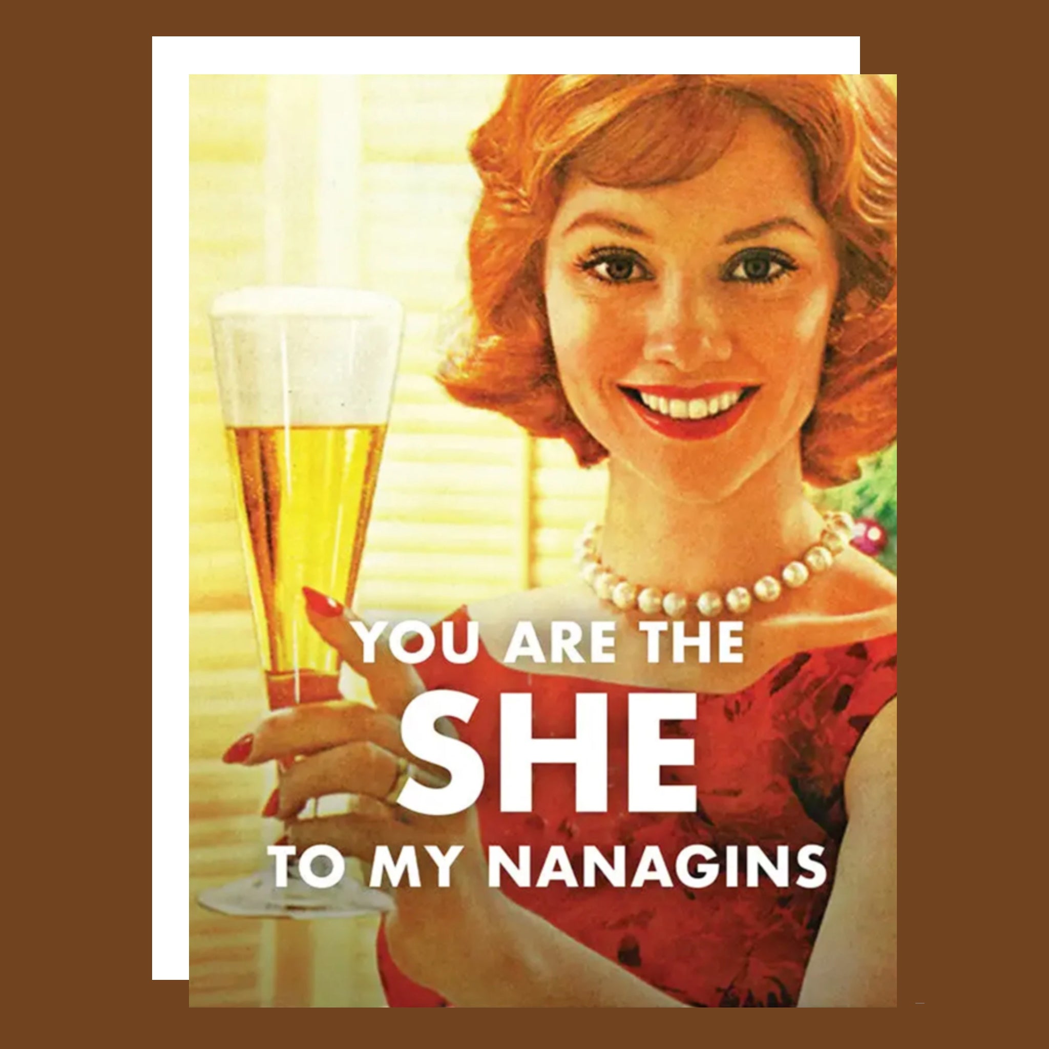 A card that reads, 'You Are The She To My Nanigans' with a photo of a woman holding a glass of champagne. 