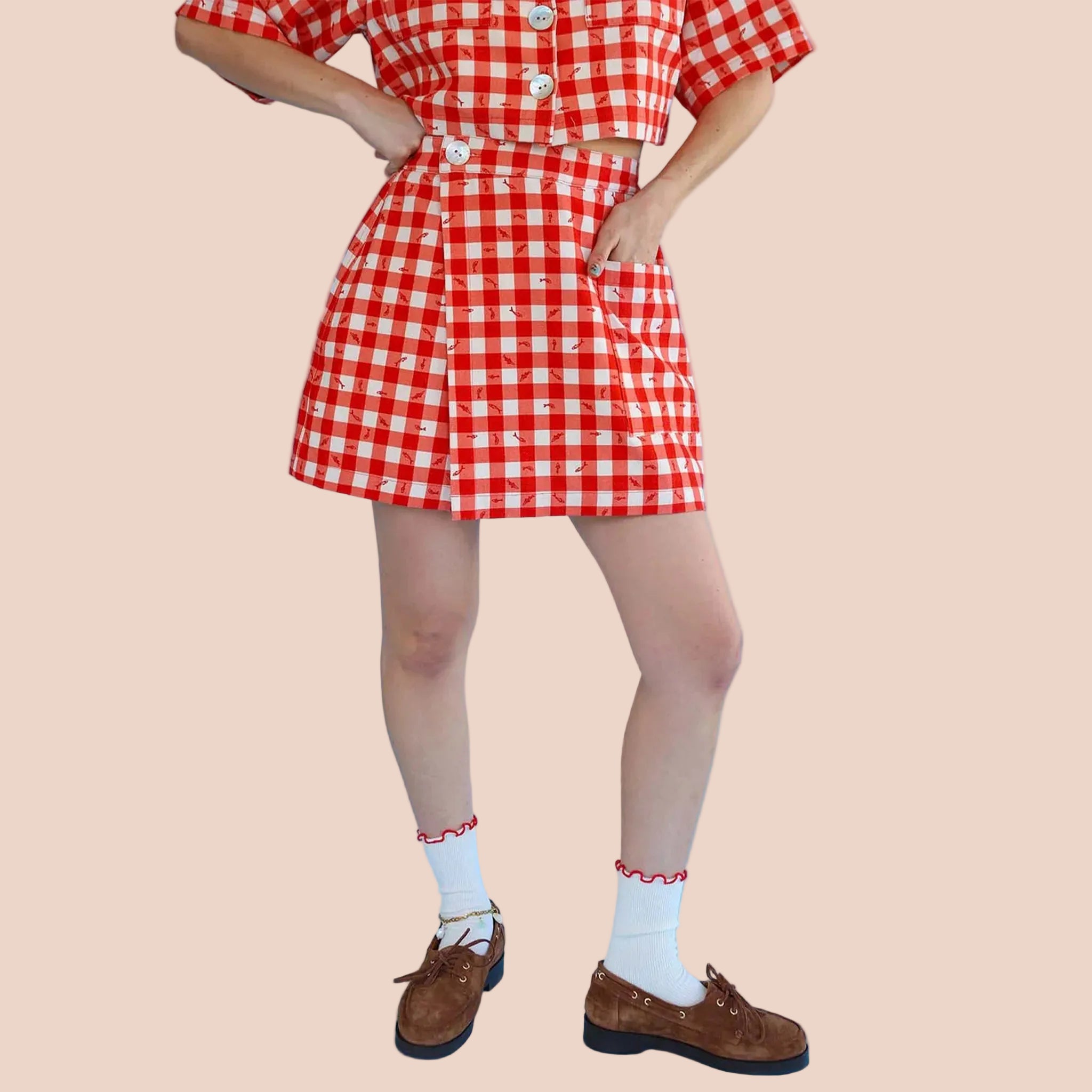 A red gingham print and fish pattern skort. 
