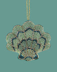 A green beaded shell shaped ornament. 