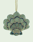 A green beaded shell shaped ornament. 