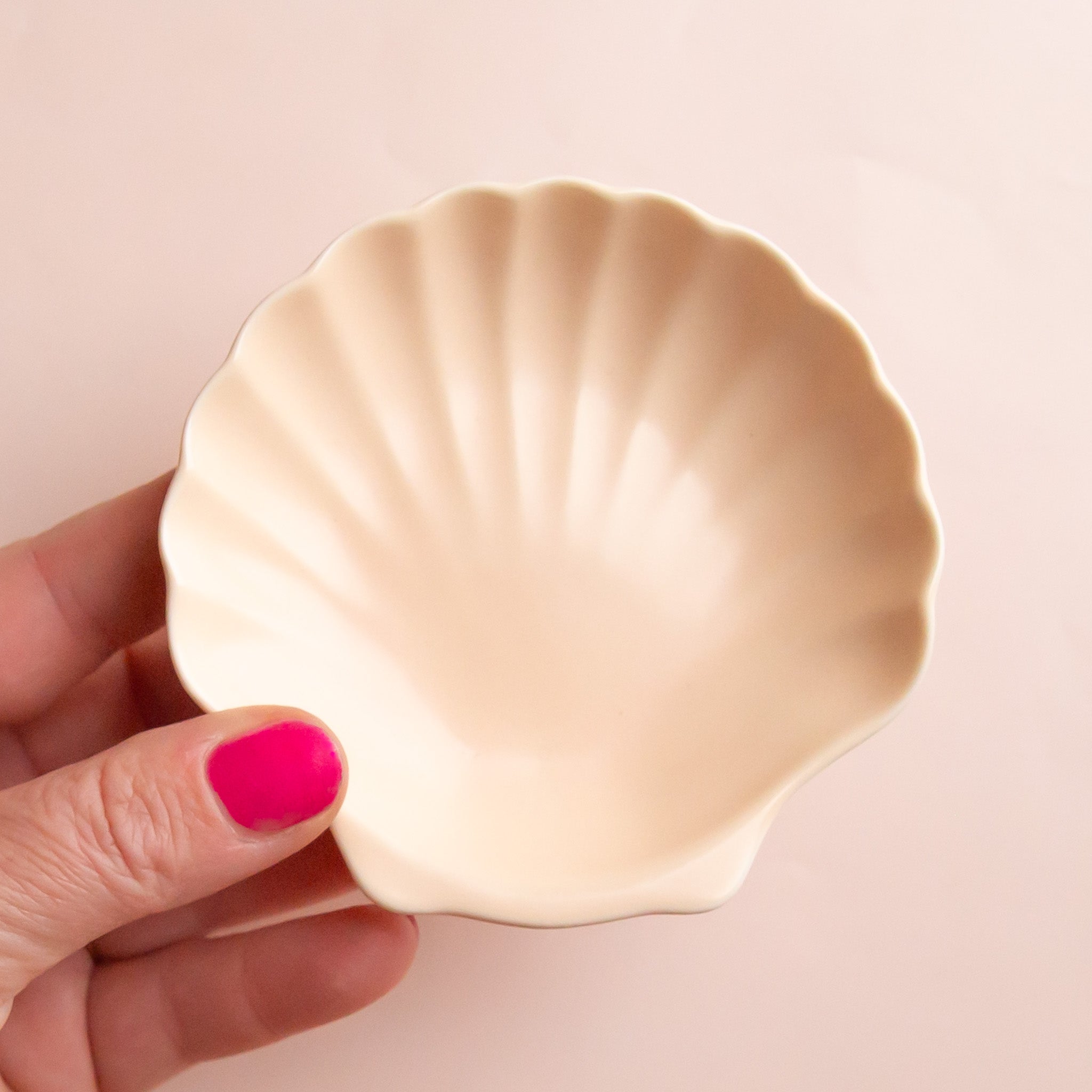 A seashell shaped ceramic trinket dish. 