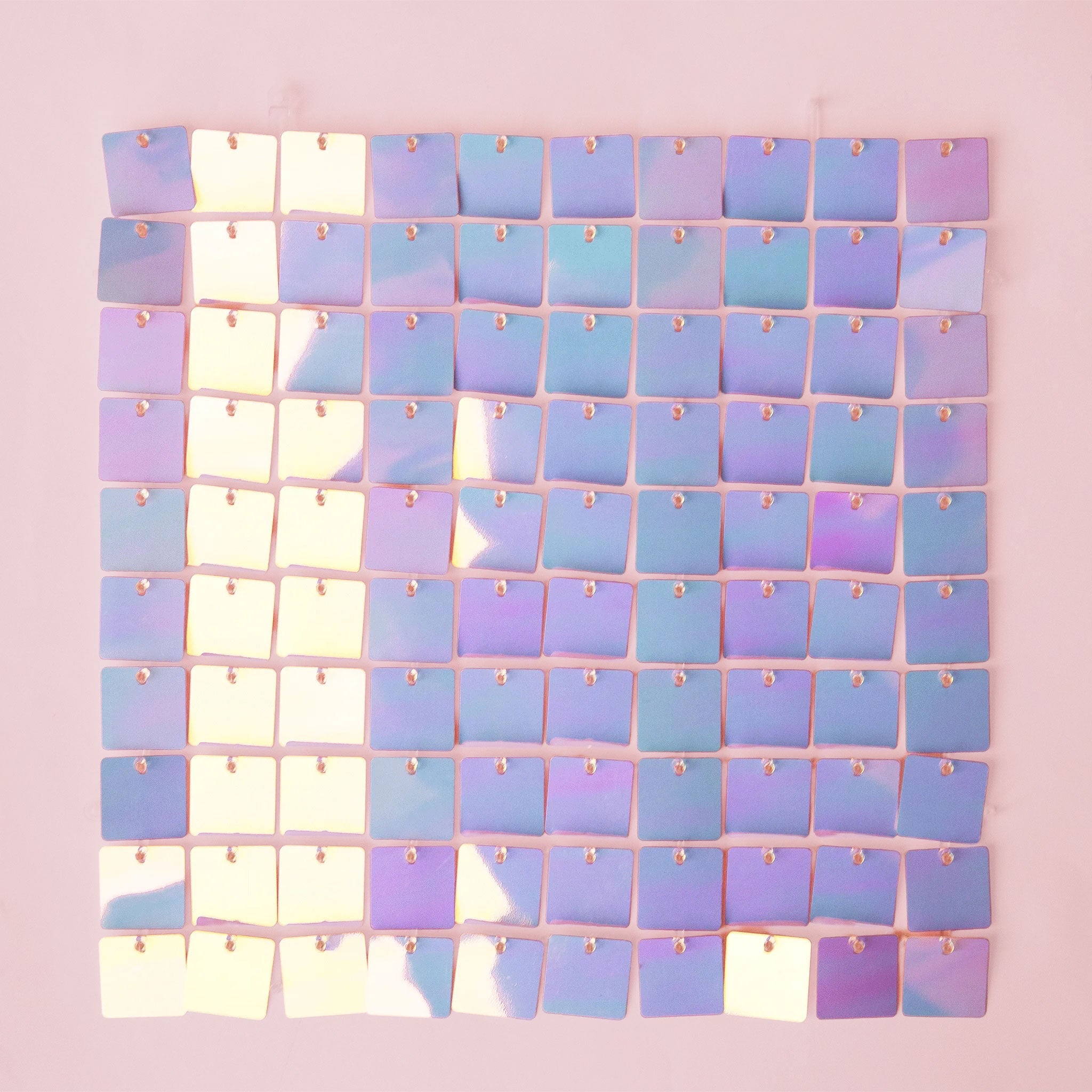 On a lavender background is a purple/blue shiny decorative wall panel.